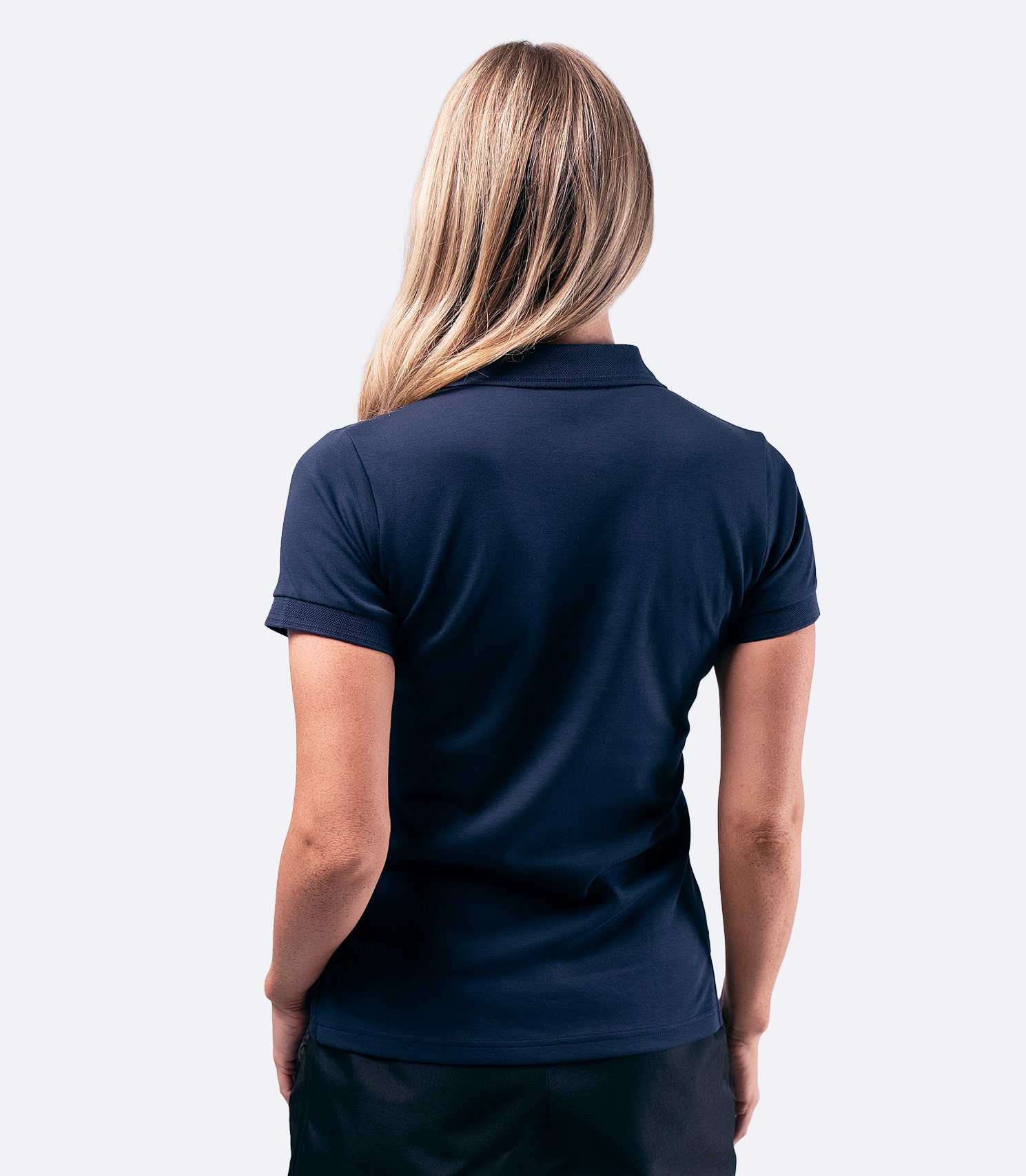 Back view of Zhik Women's Pima Cotton Polo in navy, featuring breathable fabric and a refined silhouette.