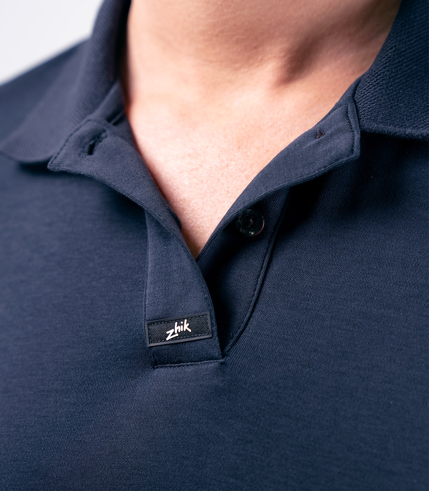 Detail view of Zhik Women's Pima Cotton Polo in navy, highlighting the textured collar and luxurious cotton.