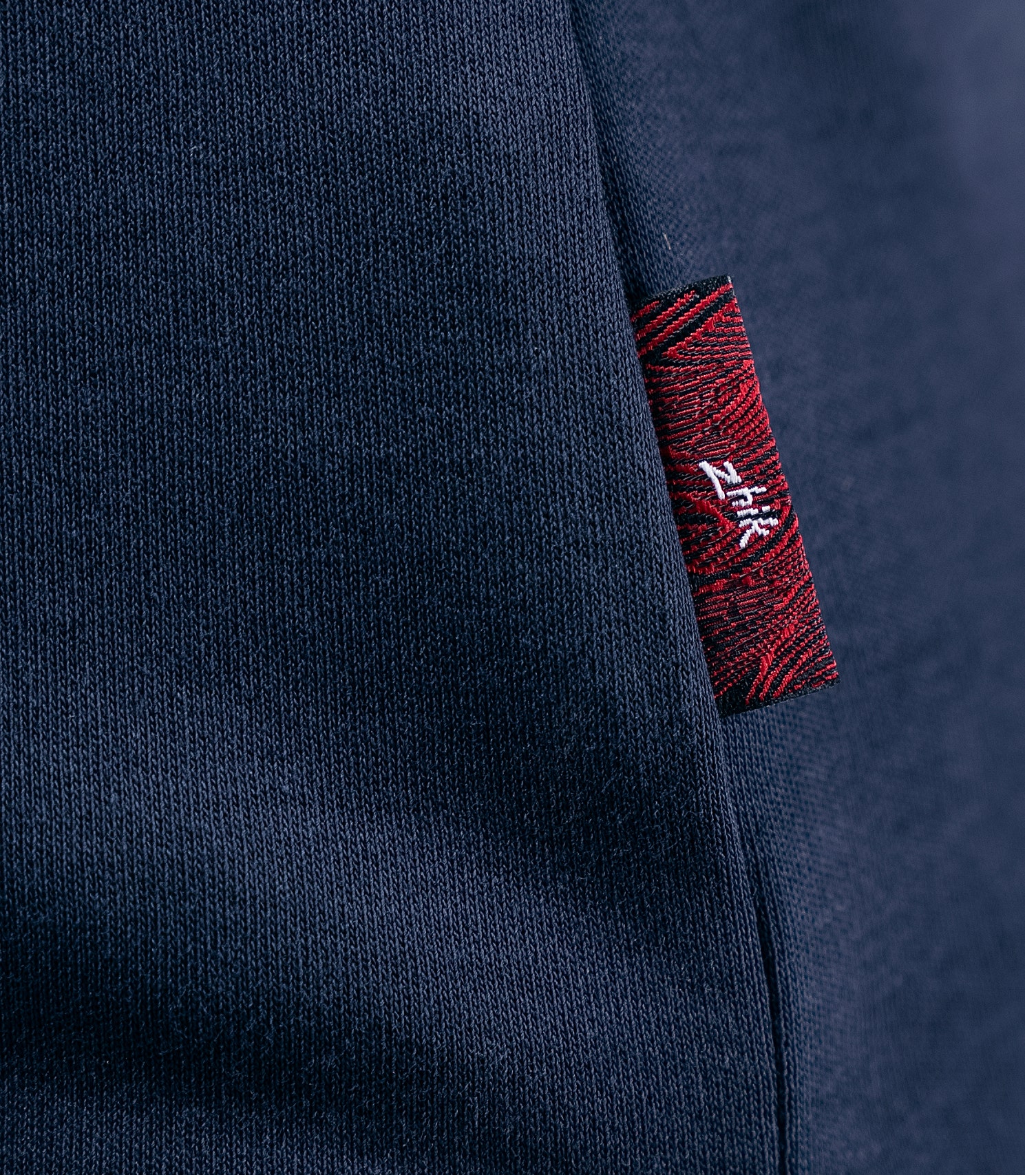 Detailed view of Zhik Women's Pima Cotton Polo fabric in navy, highlighting the soft, breathable 205gsm Supima cotton texture.