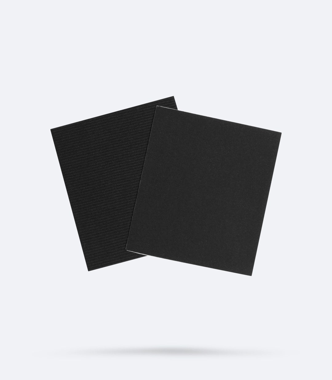 Two black repair patches from the Zhik Smash Repair Kit – durable nylon and Zhiktex™ patches for easy iron-on wetsuit repairs.