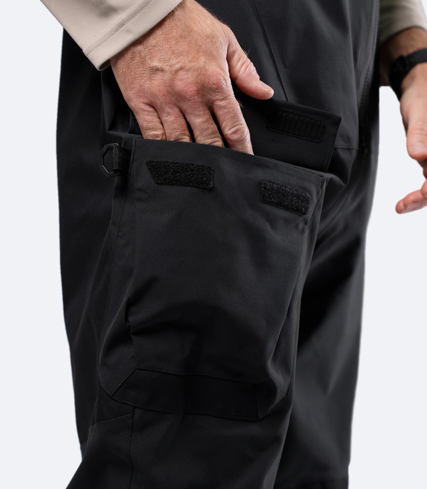 Close-up of cargo pocket on Zhik INS400 black salopette thigh, showing durable reinforced panel