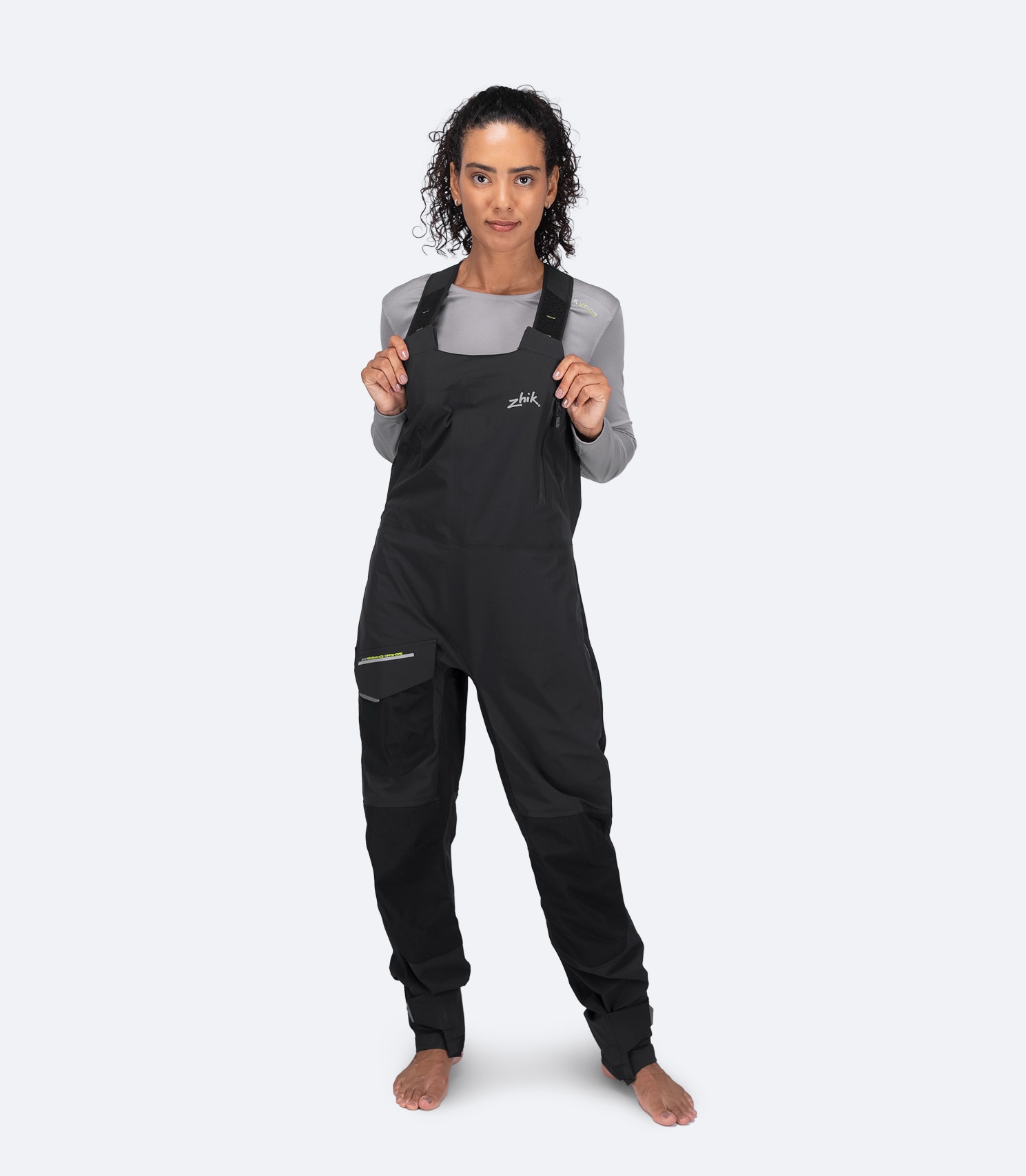 Front view of Zhik Women's OFS700 Offshore Sailing Salopette in black with articulated knees and water-resistant 2-way front zipper.