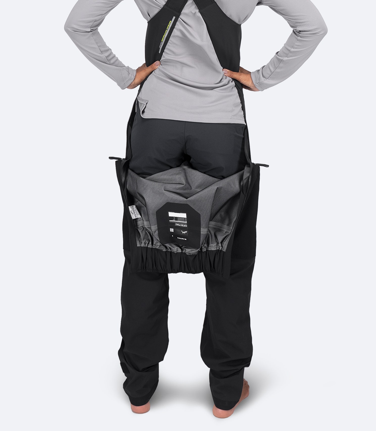 Close-up of Zhik Women's OFS700 Salopette in black showing water-resistant drop-seat entry for easy access