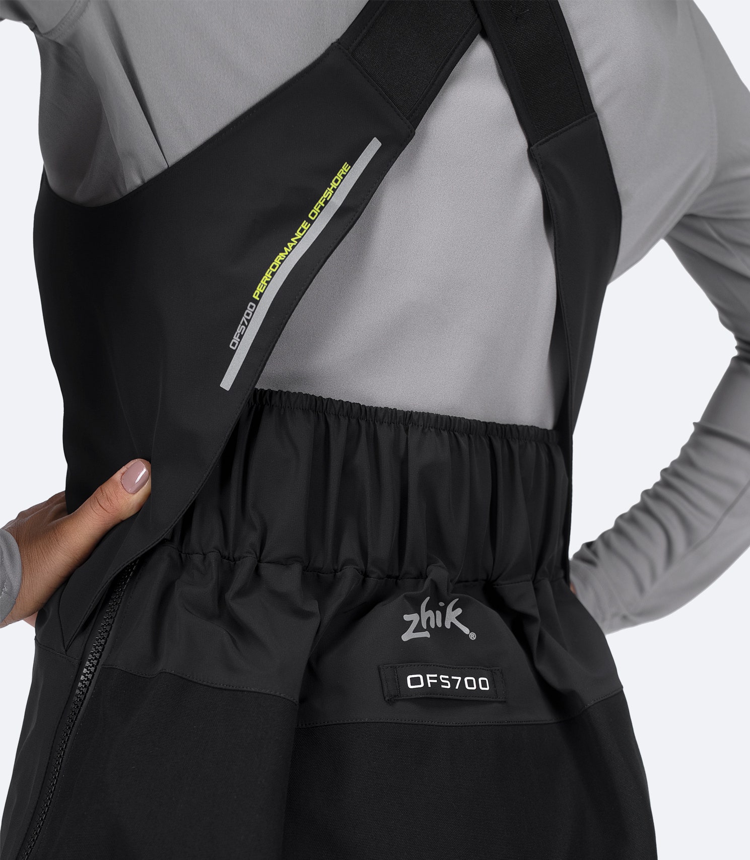 Rear back detail of Zhik Women's OFS700 Salopette in black with seam-taped construction and reinforced back hem.