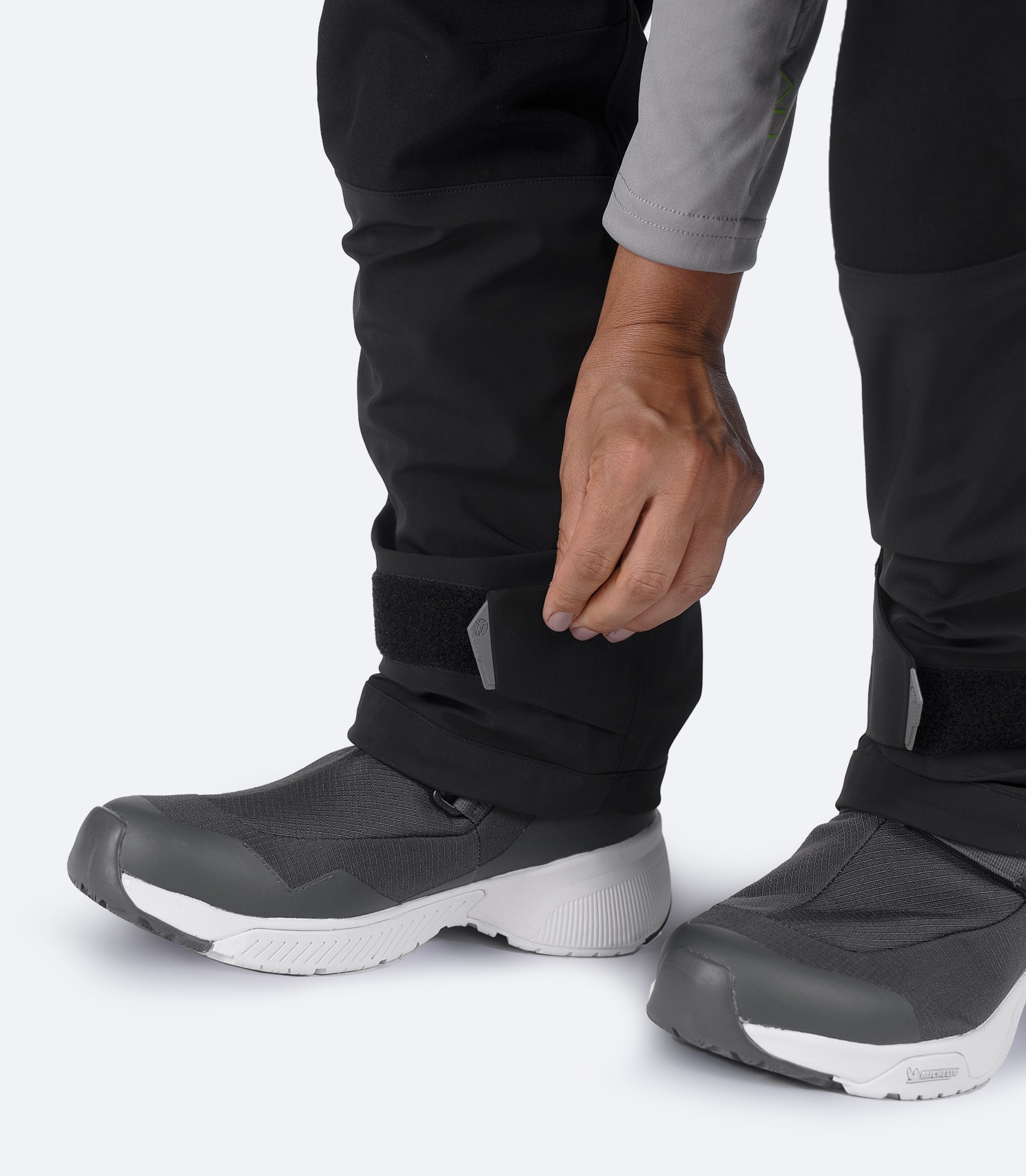 Ankle Velcro detail on Zhik Women's OFS700 Salopette in black with reinforced closure for adjustable watertight fit.