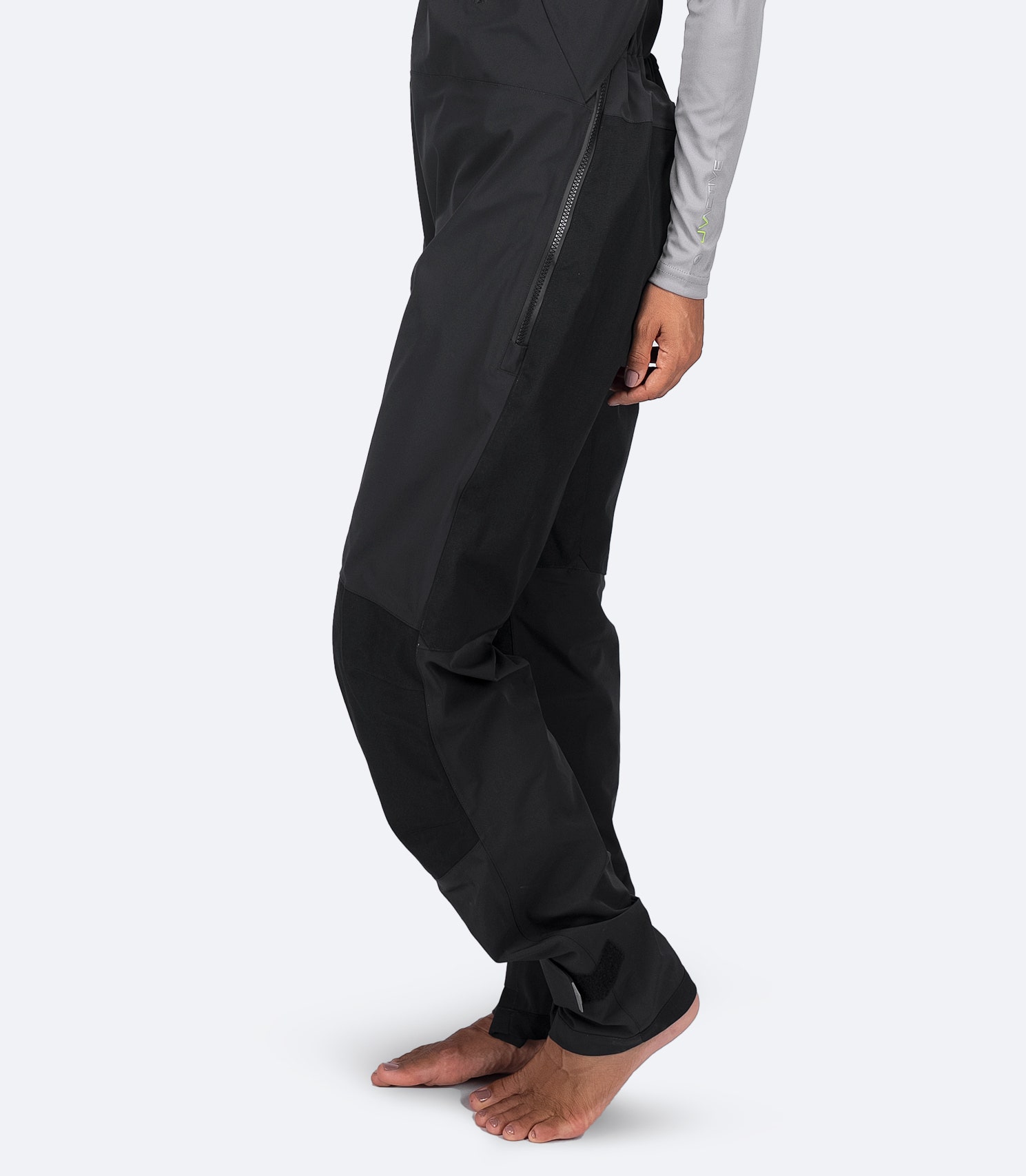 Side leg close-up of Zhik Women's OFS700 Salopette in black with articulated knees and 500D nylon reinforcements.