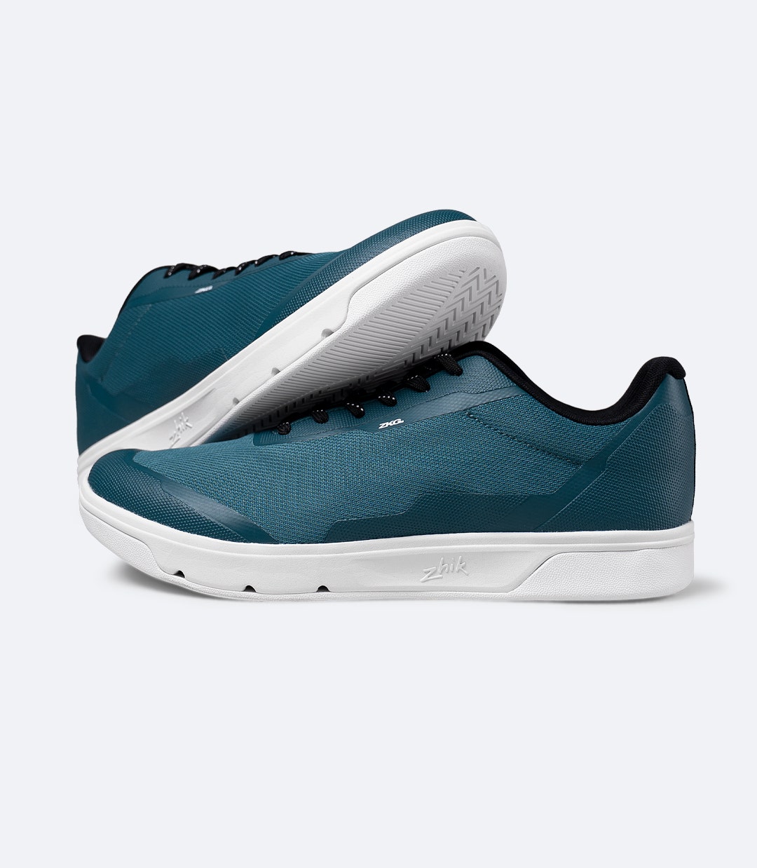 Two Zhik ZKG Amphibious Shoes in deep teal stacked, highlighting flexible EVA midsole and marine-ready build