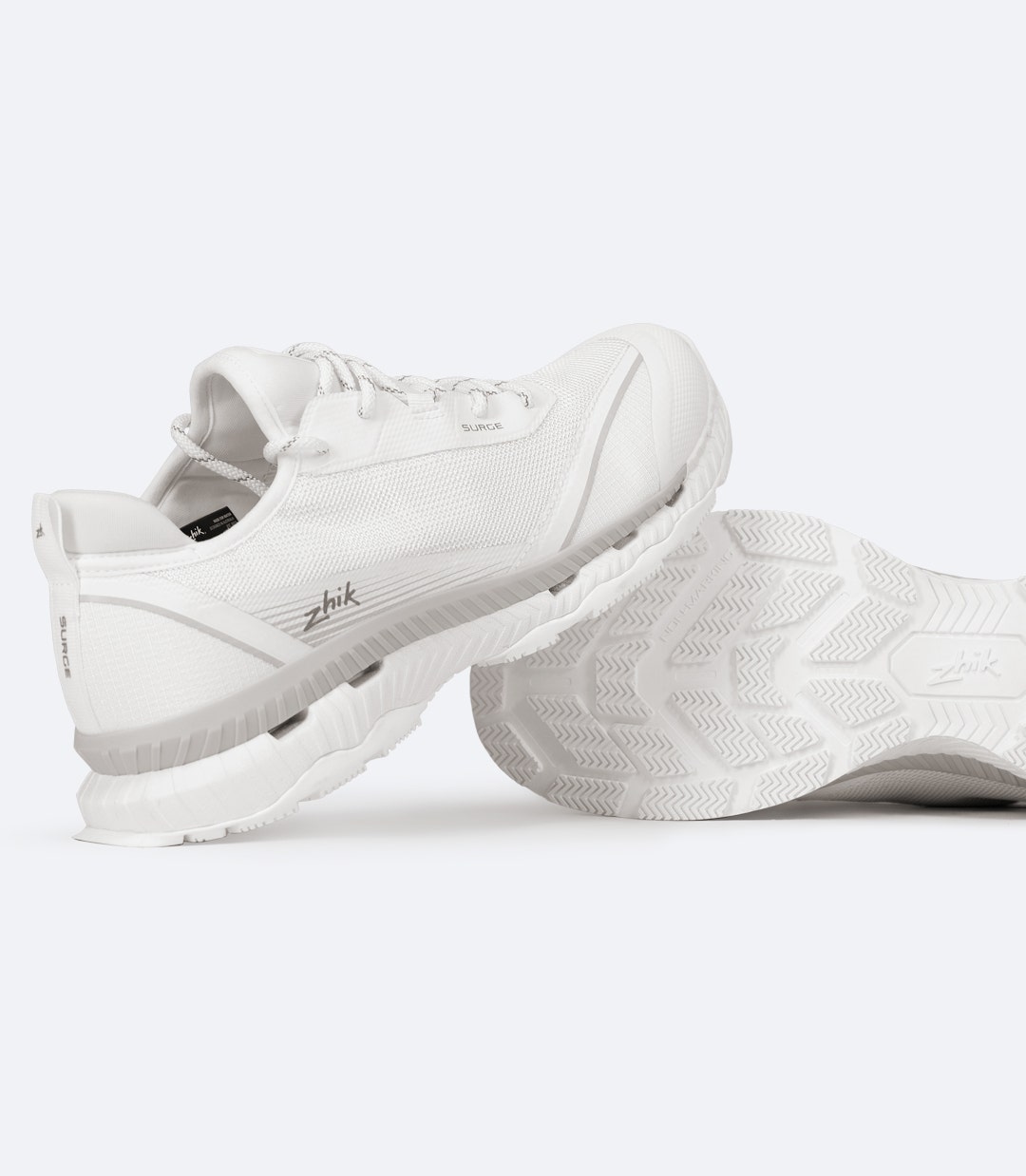 White Zhik Surge Shoe with sole and heel visible, showing aggressive grip tread and rear loop for easy entry.