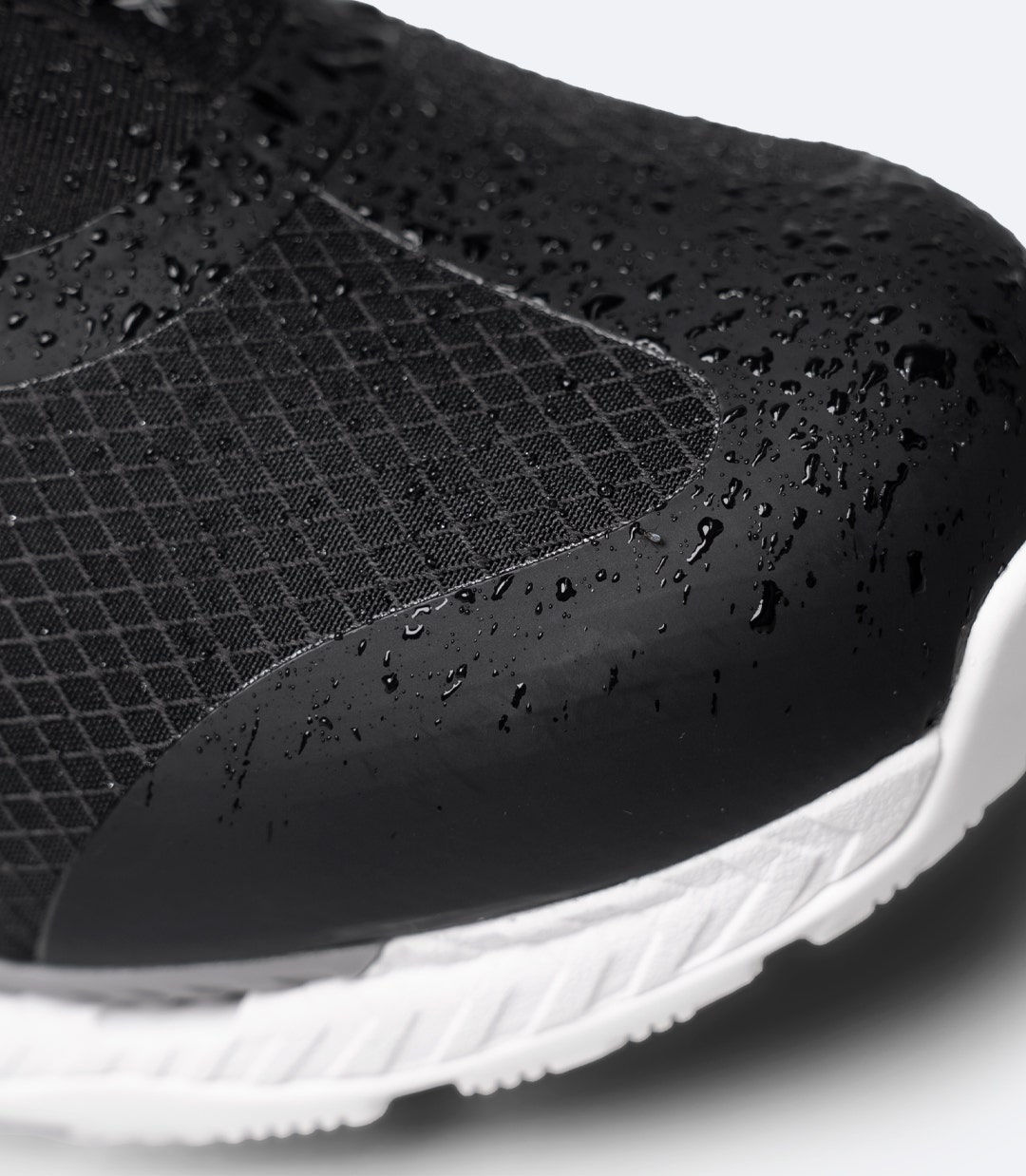 Close-up of Black Zhik Surge X waterproof shoe toe showing abrasion-resistant TPU panels and mesh upper