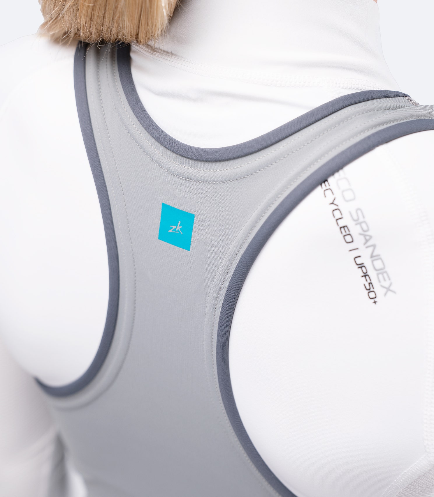 Close-up of grey Zhik skiff suit racerback straps over shoulders, designed for mobility and comfort while sailing