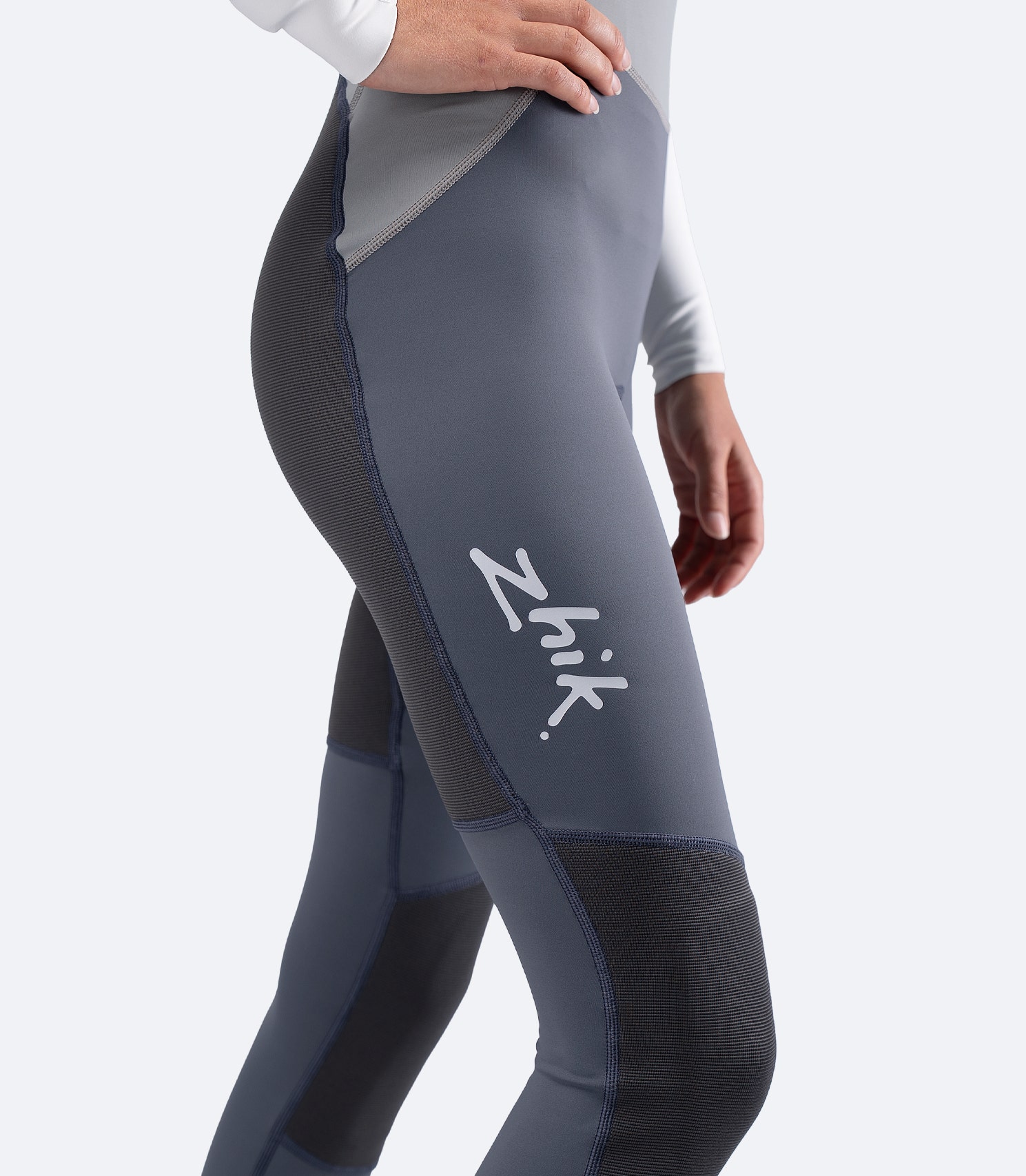 Side view of legs on Zhik Women's Hybrid Gear Performance Skiff Suit in grey, featuring Zhik logo and streamlined fit