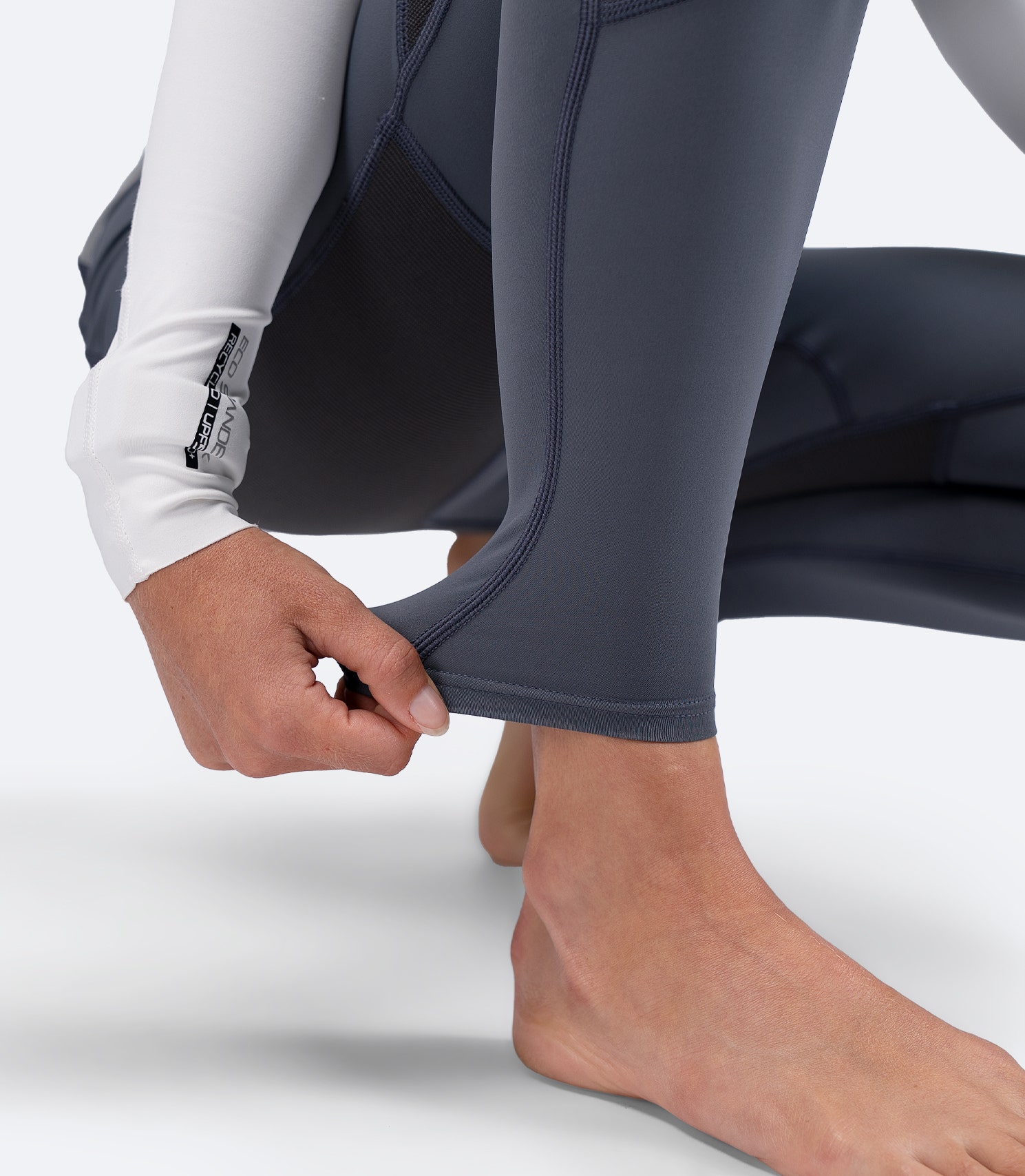 Close-up of ankle opening on Zhik Women's Hybrid Gear Performance Skiff Suit in grey, showing soft stretch finish for comfort