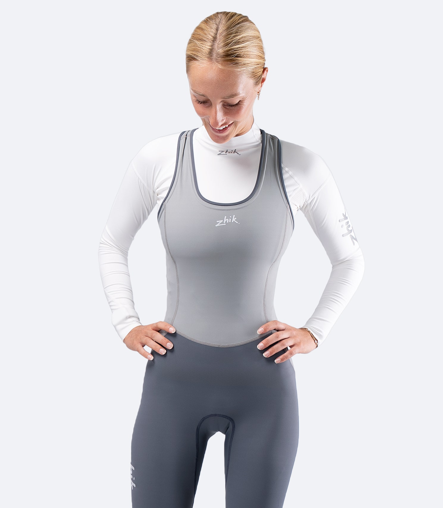 Knee to head front view of Zhik Women's Hybrid Gear Performance Skiff Suit in grey with UPF 50+ protection and flatlock seams.