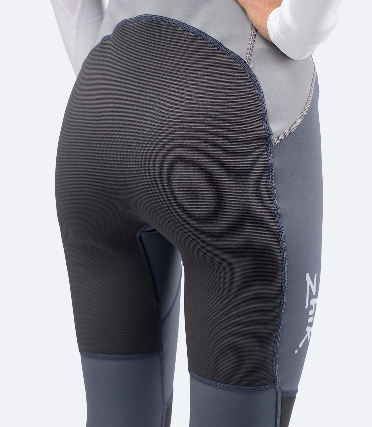 Close-up rear seat of Zhik Women's Hybrid Gear Performance Skiff Suit in grey with ZhikTex II reinforcement for deck wear.