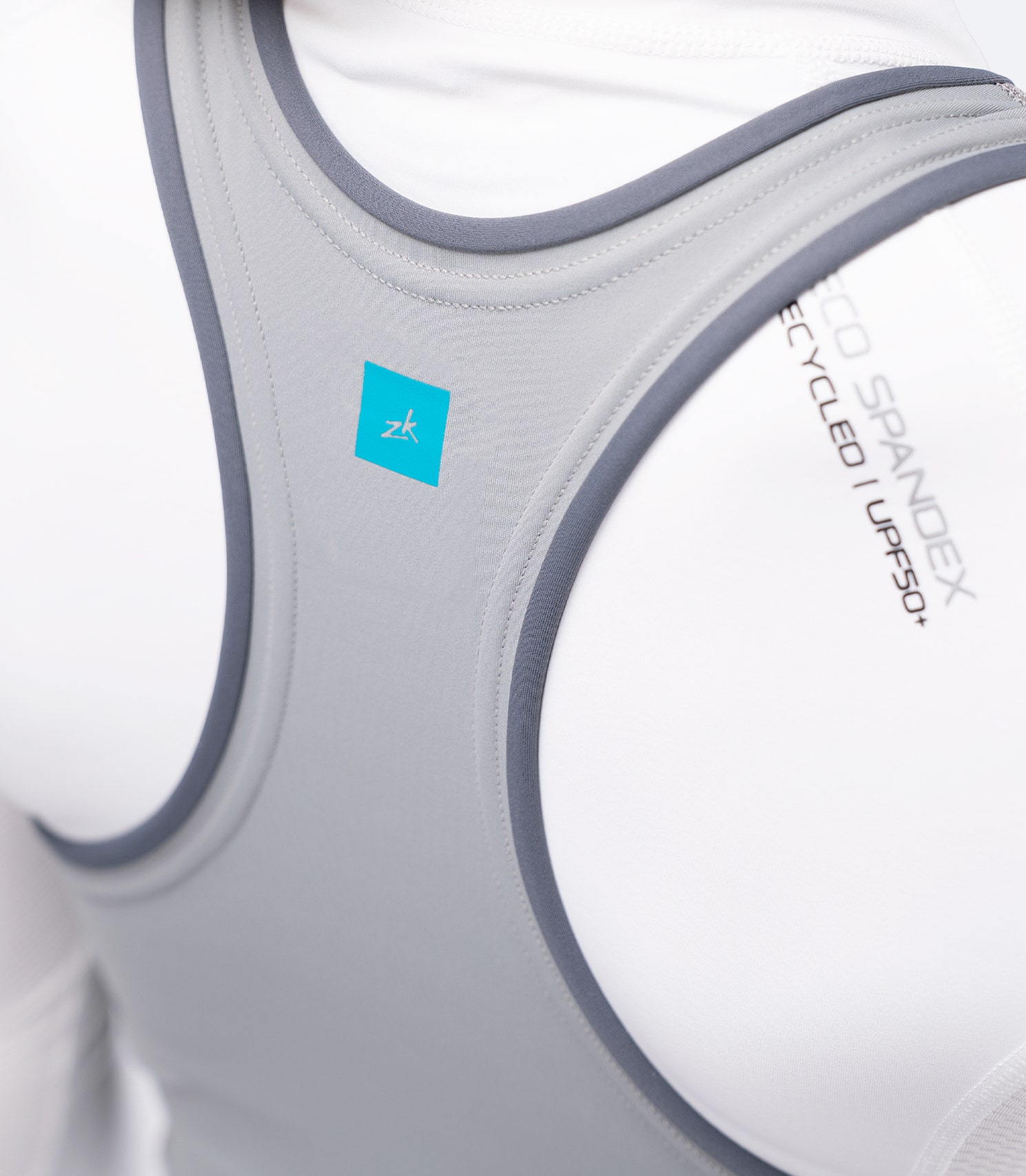 Close-up of Zhik Youth Hybrid Gear Performance Skiff Suit in Grey showing rear shoulder straps and low-profile finish