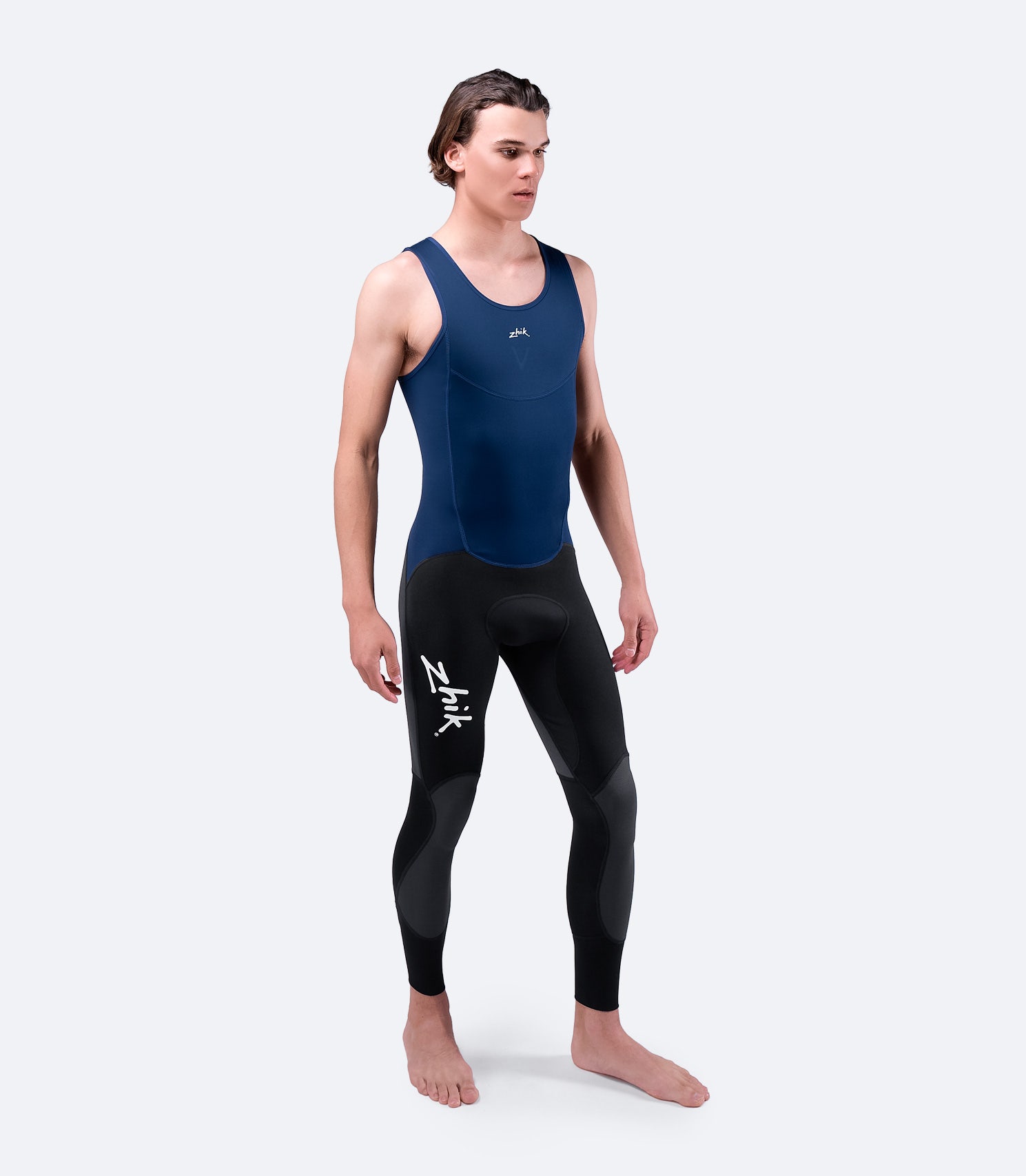 Navy Zhik Microfleece™ V Skiff Suit, front view worn by model, showcasing streamlined fit and insulating neoprene material.