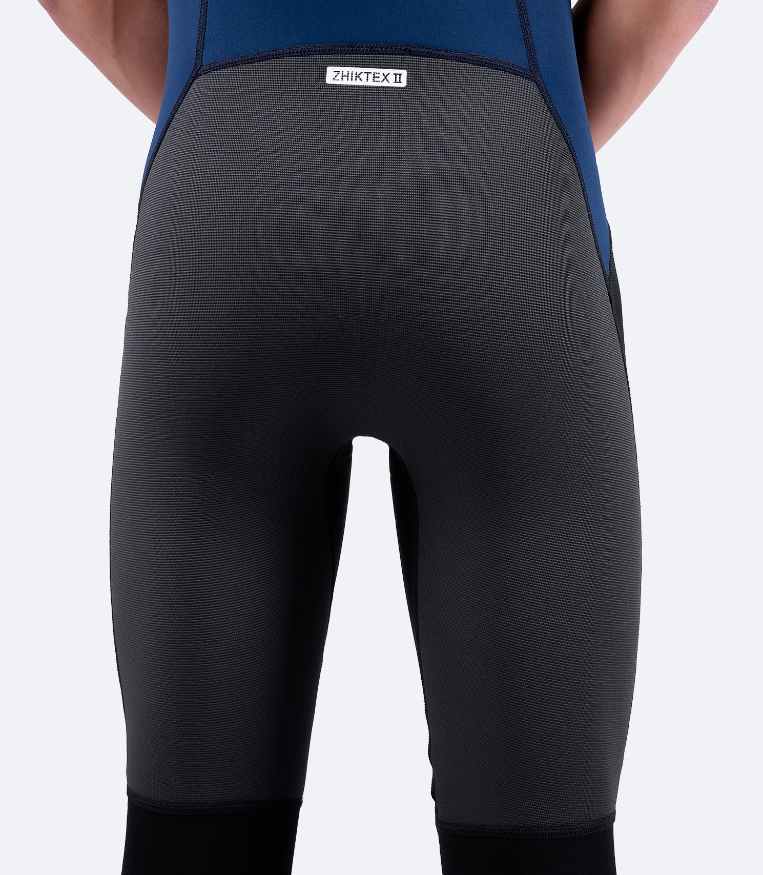Close-up of lower back and waist on Zhik Microfleece™ V Skiff Suit, emphasizing 3D body-mapped fit and durable stitching.