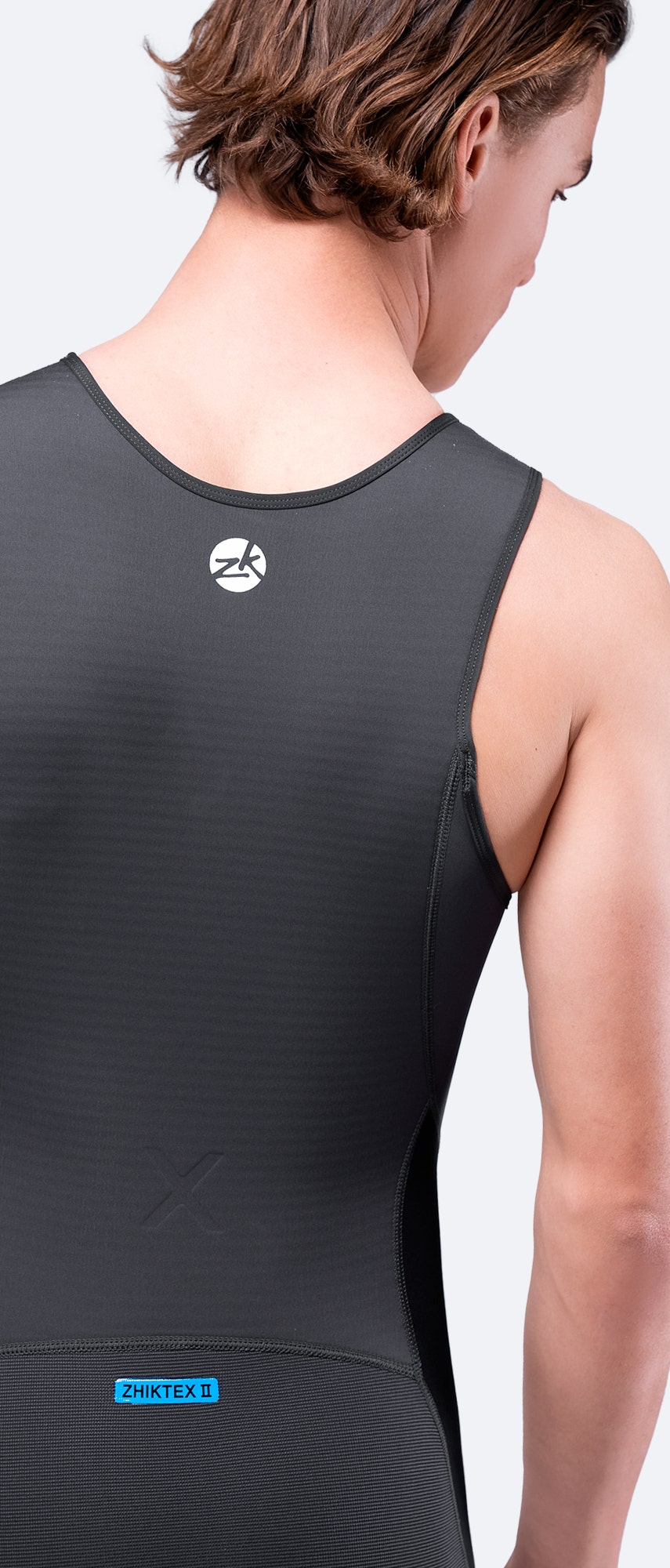 Rear shoulders and collar close-up of the black Microfleece™ X Skiff Suit, displaying reinforced construction and Hydrobase® fleece lining.