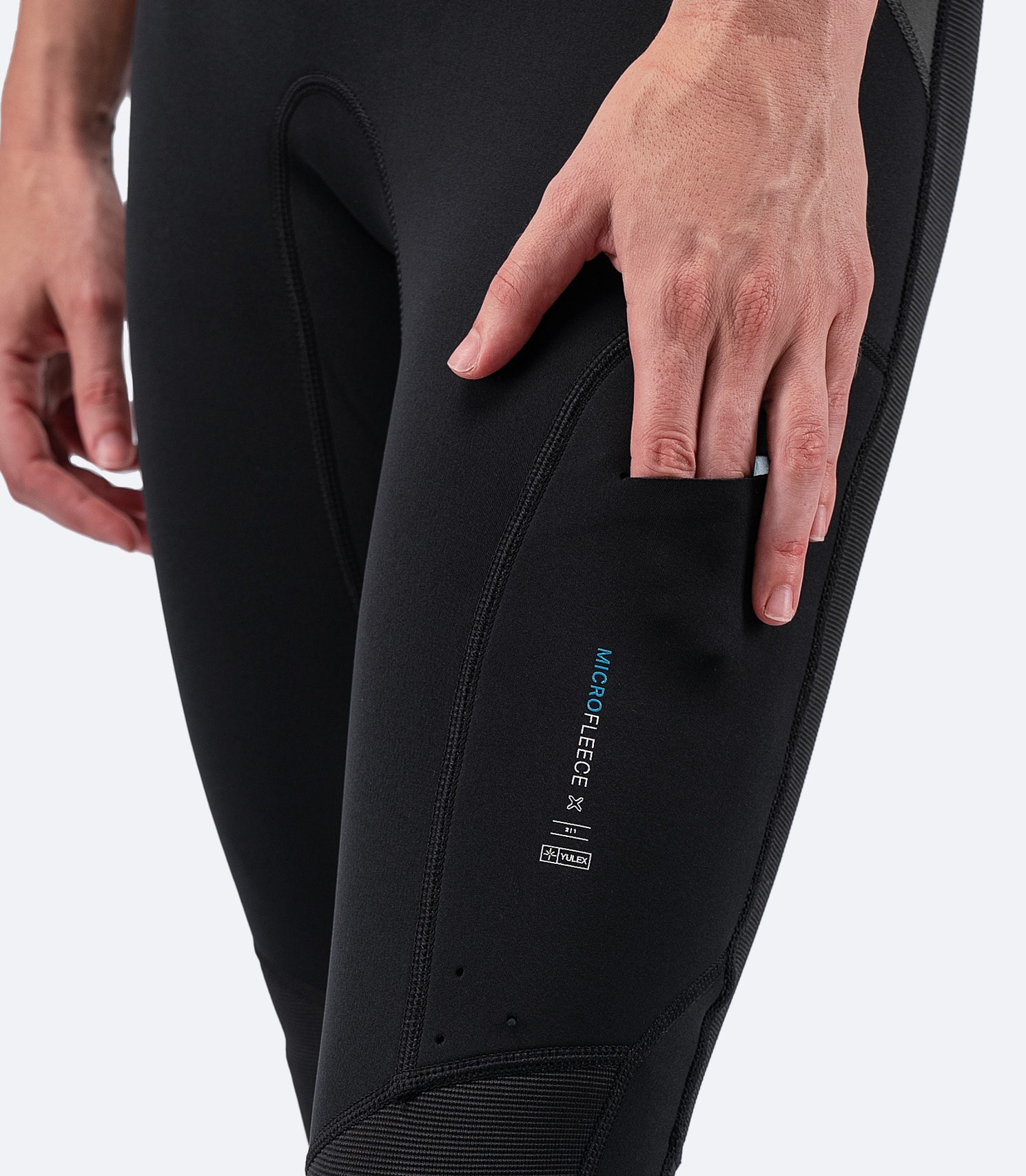 Close-up of slimline thigh pocket on Zhik Women's MicrofleeceX Skiff Suit, designed for easy storage on the water.