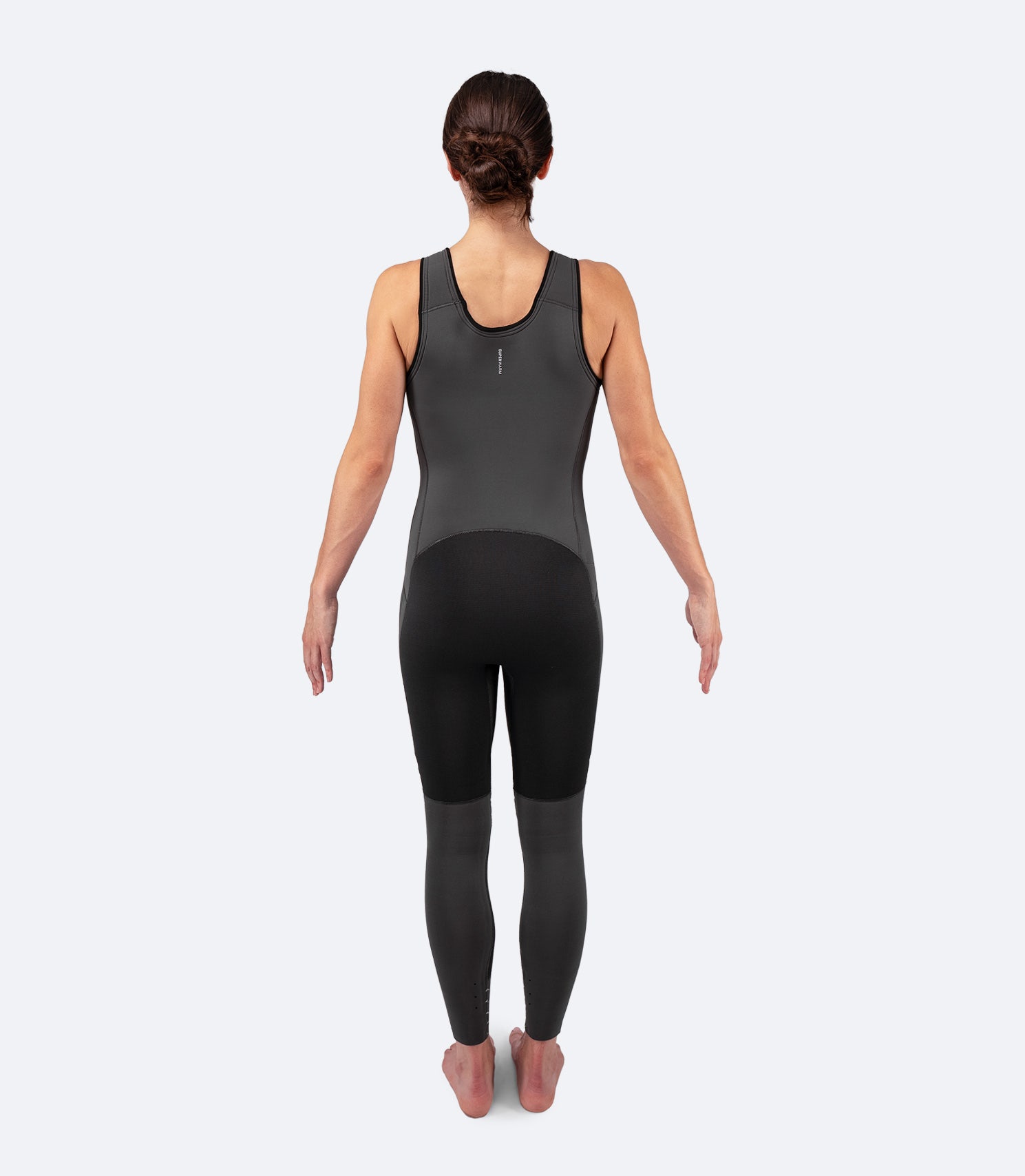 Back view of Zhik Women's Superwarm Skiff Suit displaying high-rise seat and extended shin protection with ZhikTex II reinforcement