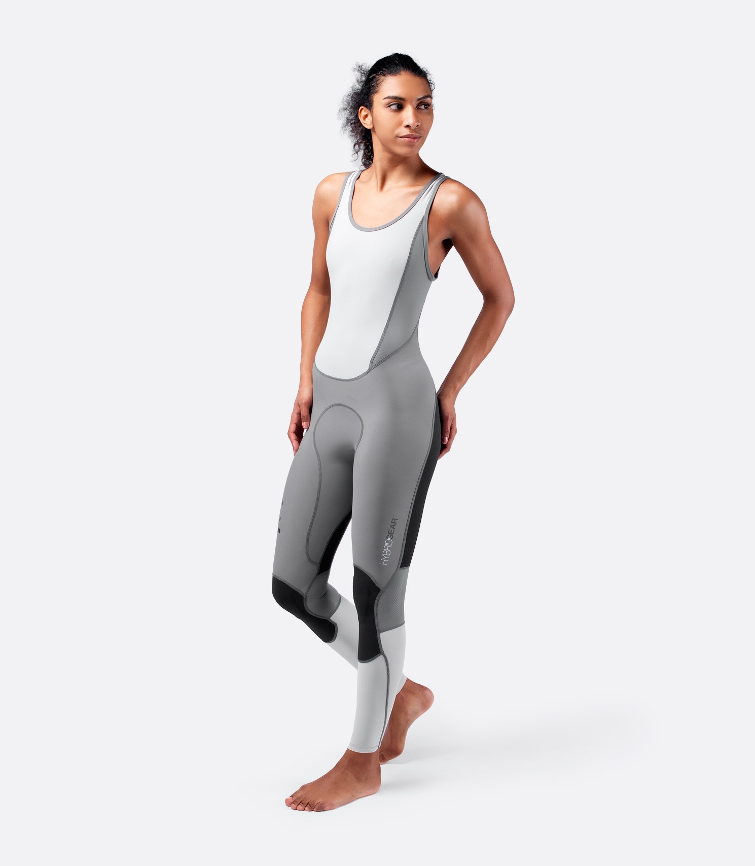 Front view of grey Zhik Hybrid Skiff Suit worn by a model, featuring 4-way stretch spandex and breathable mesh panels for high performance.