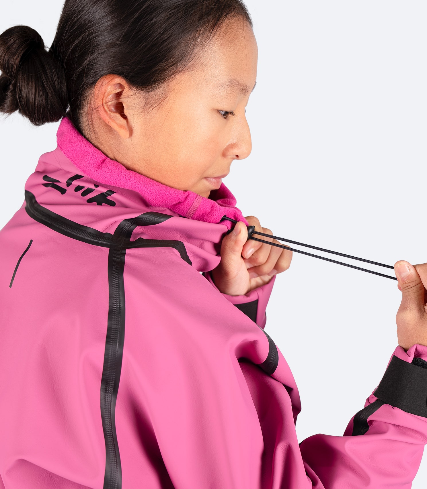 Close-up of Zhik Youth Shedding Smock in mauve collar with cord adjustment, designed for a customizable, snug fit to block out wind and water.
