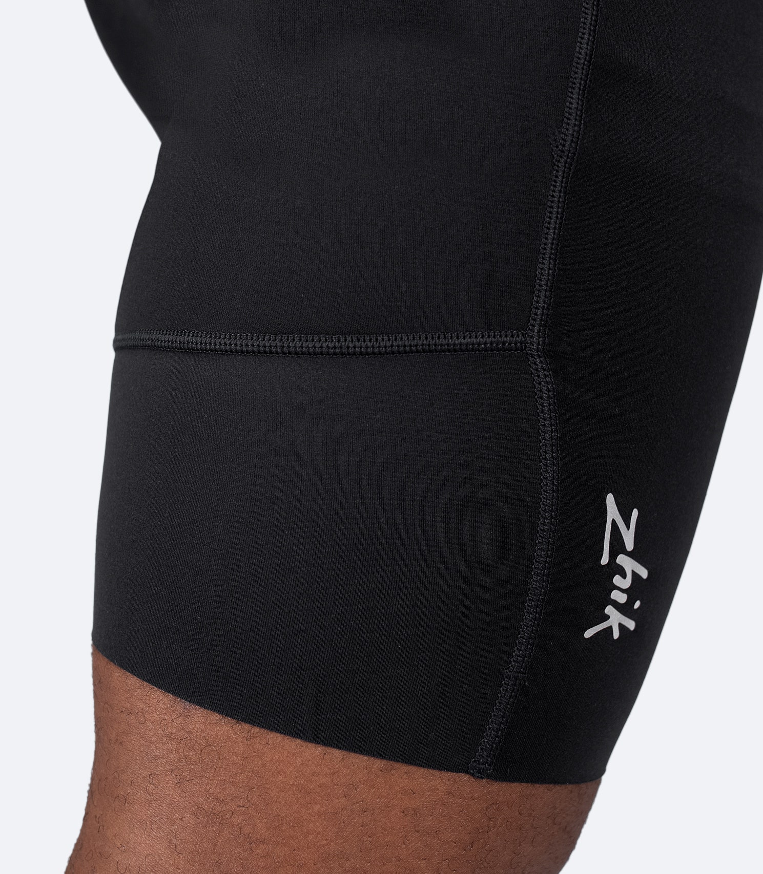 Close-up of back knee on Zhik Men's Performance Paddle Short in black highlighting breathable fabric and stretch seams.