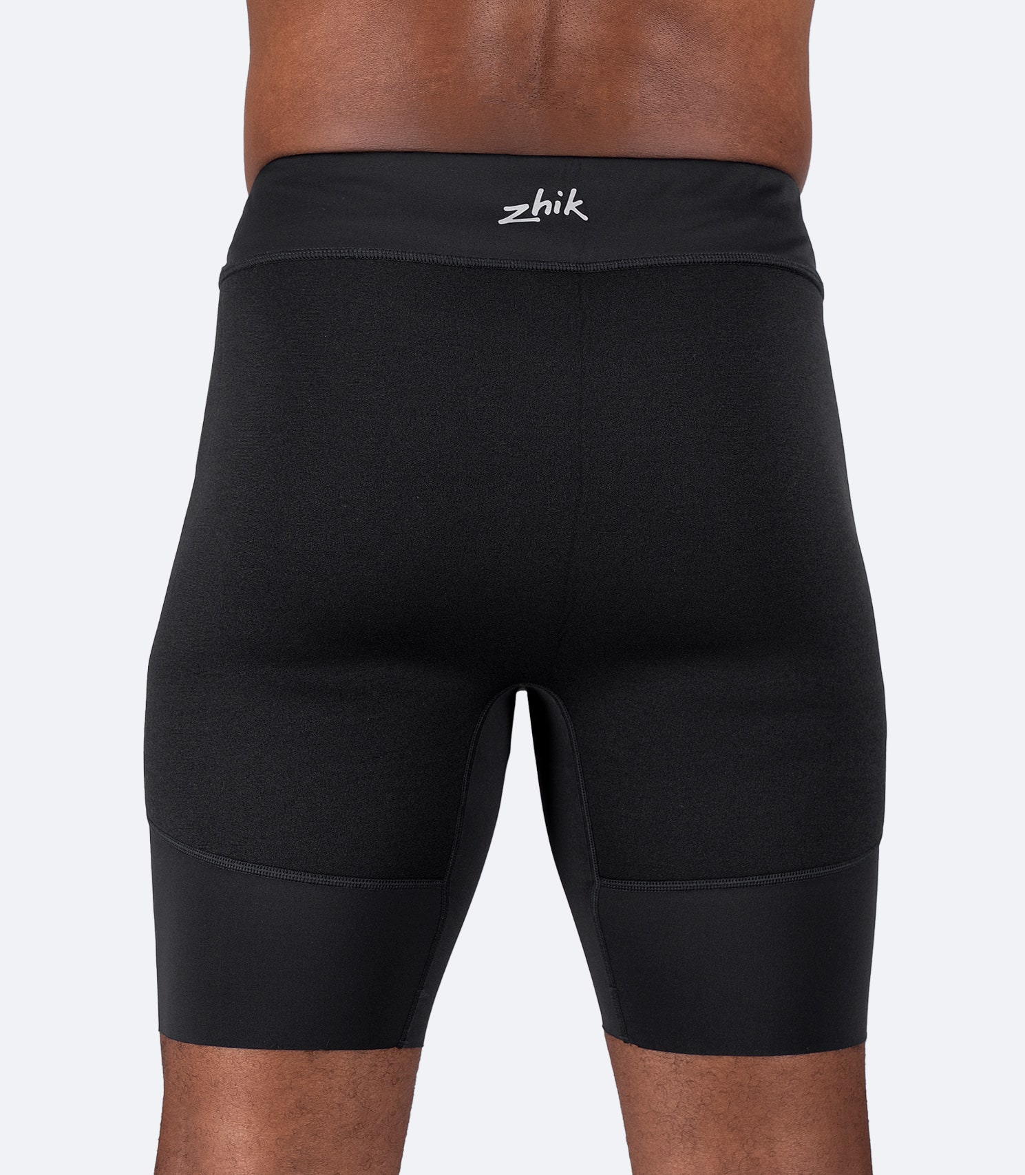 Zhik Men's Performance Padded Paddle Shorts in black, featuring a perforated padded seat and 4-way stretch recycled nylon.