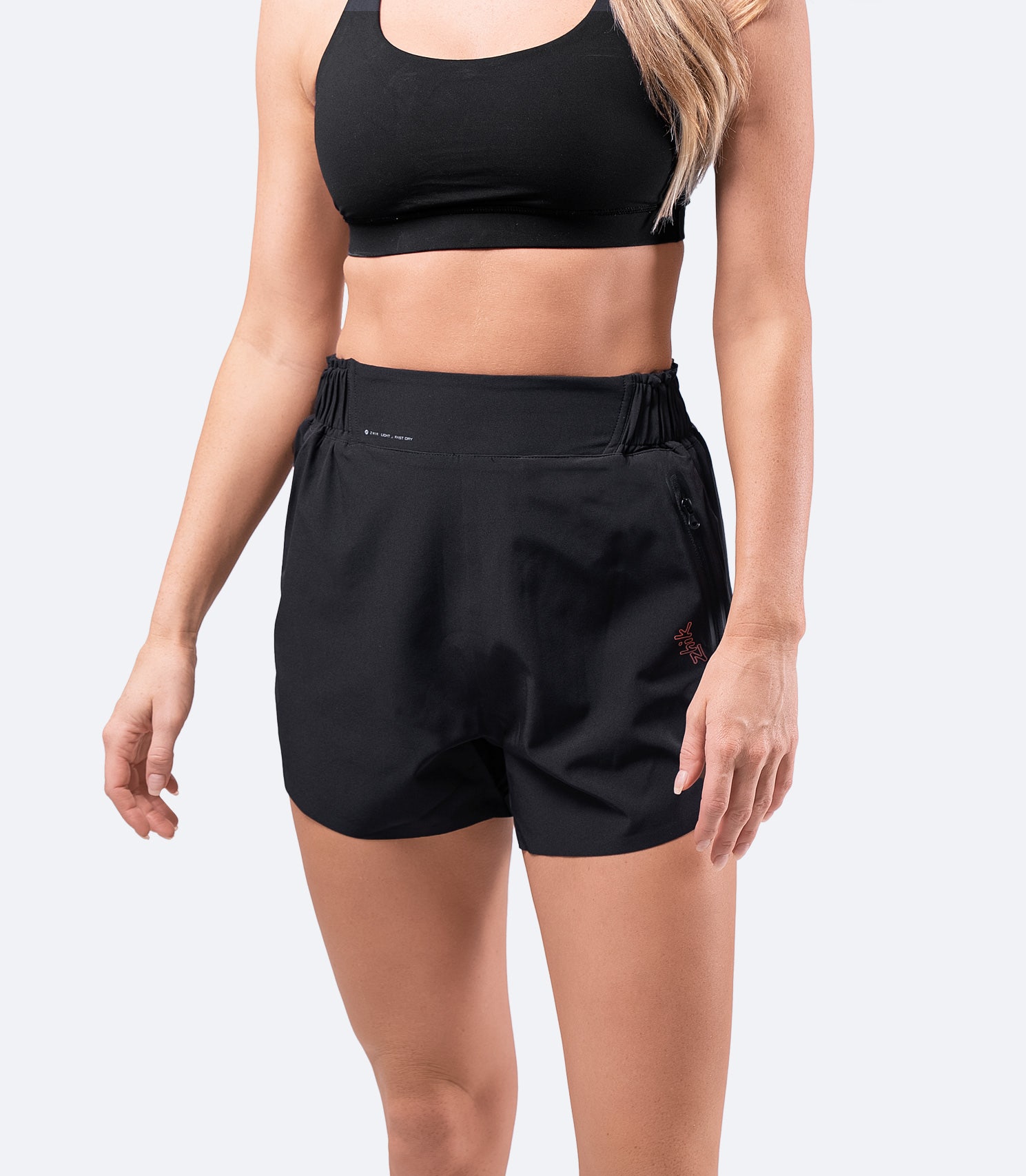 Women's black board short by Zhik – high-waisted, lightweight, and quick-drying with reinforced seams and water-repellent fabric.