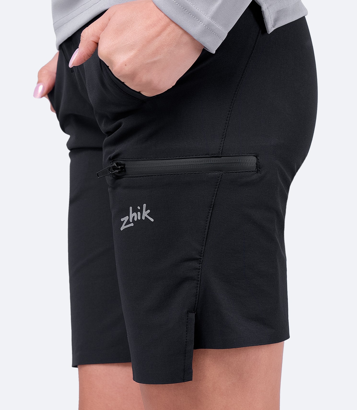 Close-up of the thigh pocket on Zhik Women's Black Deck Shorts, featuring a zippered water-resistant design for secure storage