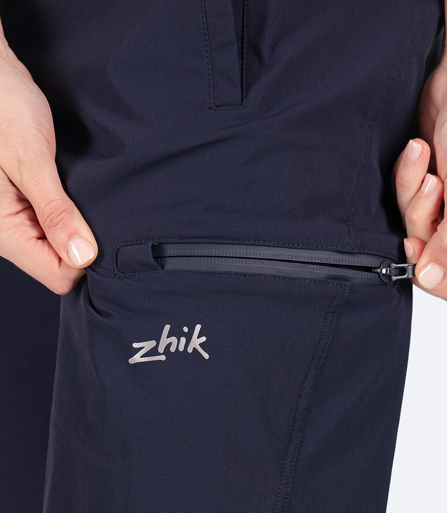 Close-up of the thigh pocket on Zhik Women's Navy Deck Shorts, featuring a zippered water-resistant design for secure storage