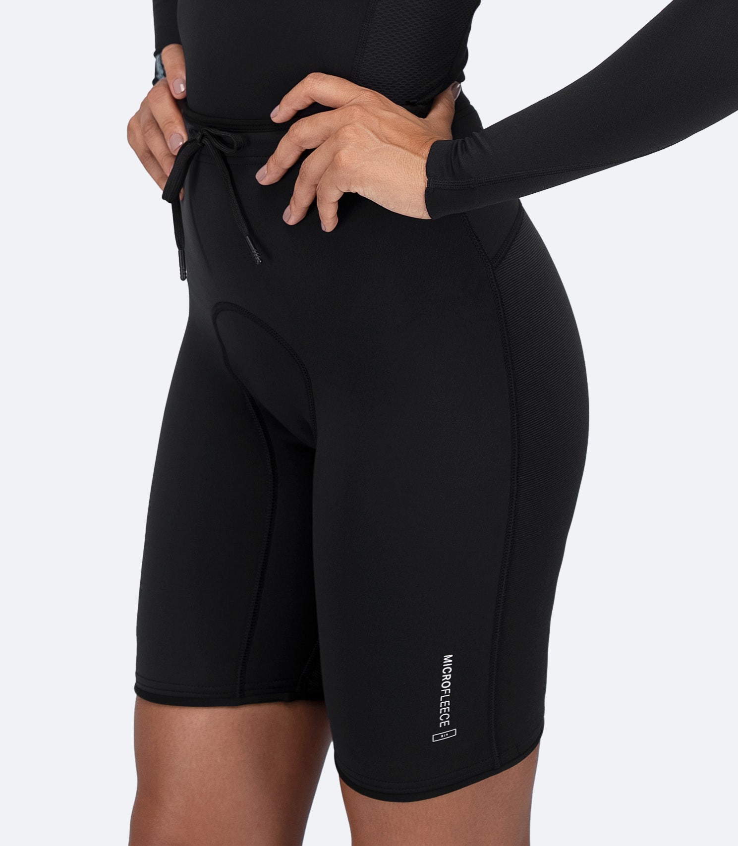 Zhik Microfleece™ Performance Shorts in black on female model, showcasing lightweight design and ergonomic fit.