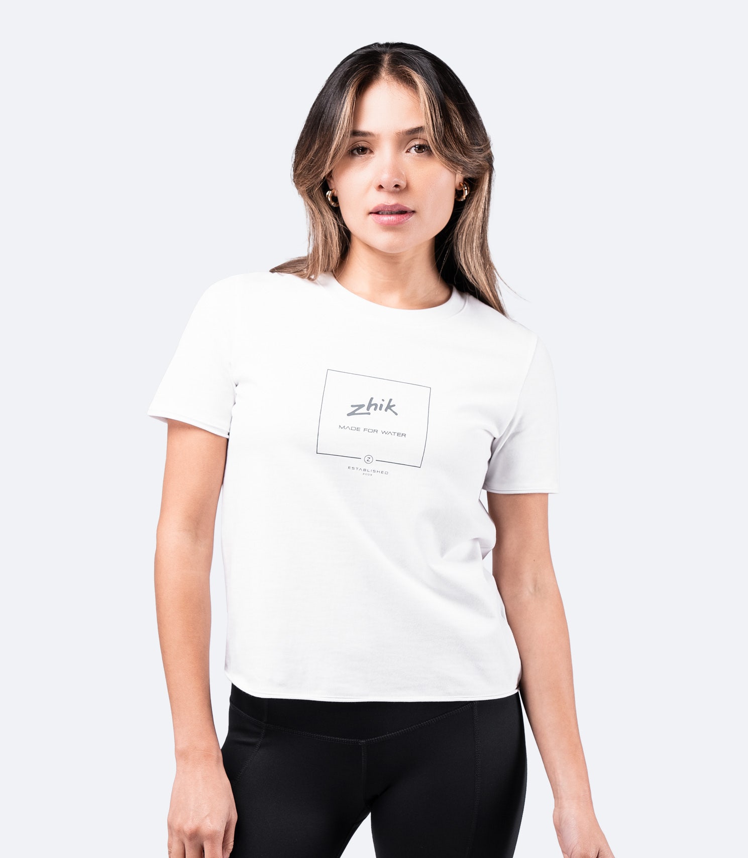 White Zhik Women's Composite Print Cotton Tee worn by model – short sleeve, soft cotton, with front logo graphic.