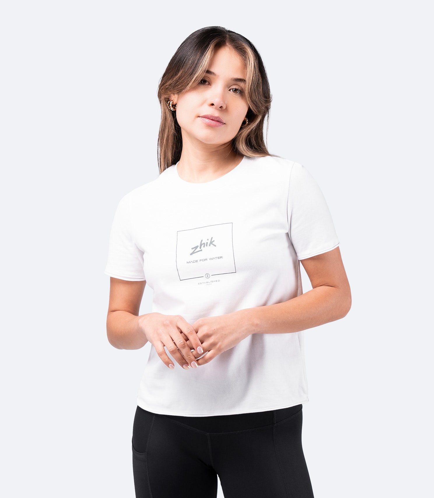 White Zhik Women's Composite Print Cotton Tee worn by model – short sleeve, soft cotton, with front logo graphic.