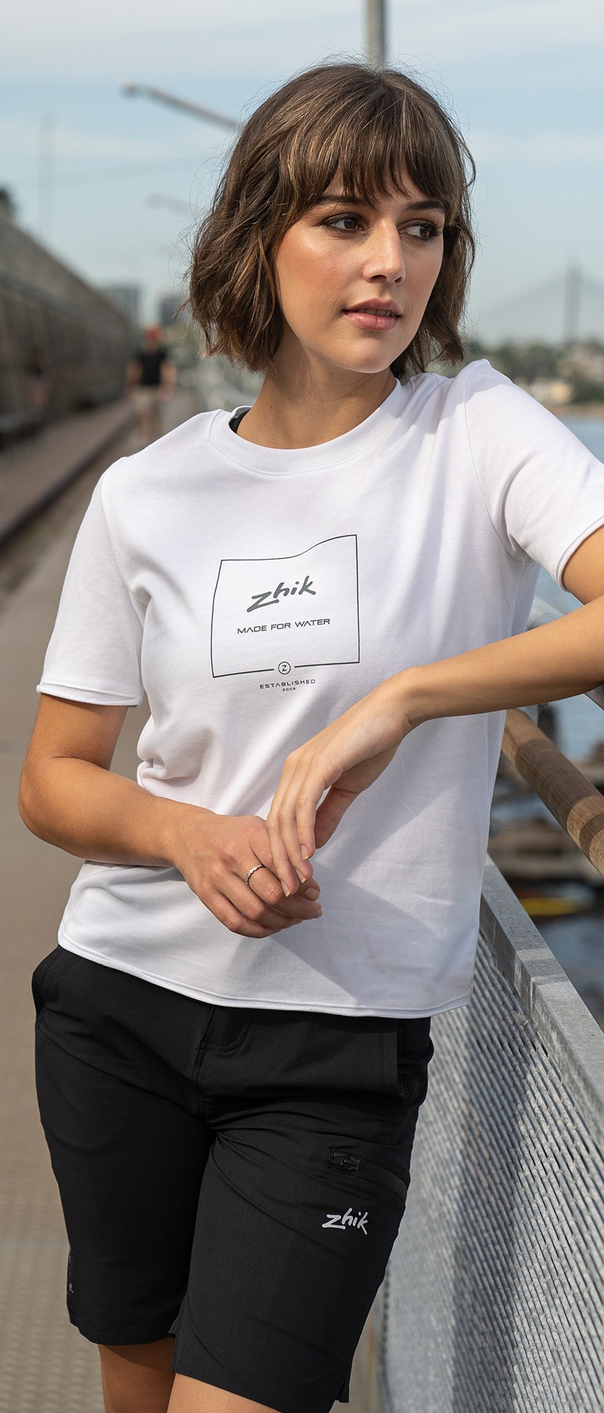 White Zhik Women's Composite Print Cotton Tee worn by model – short sleeve, soft cotton, with front logo graphic.