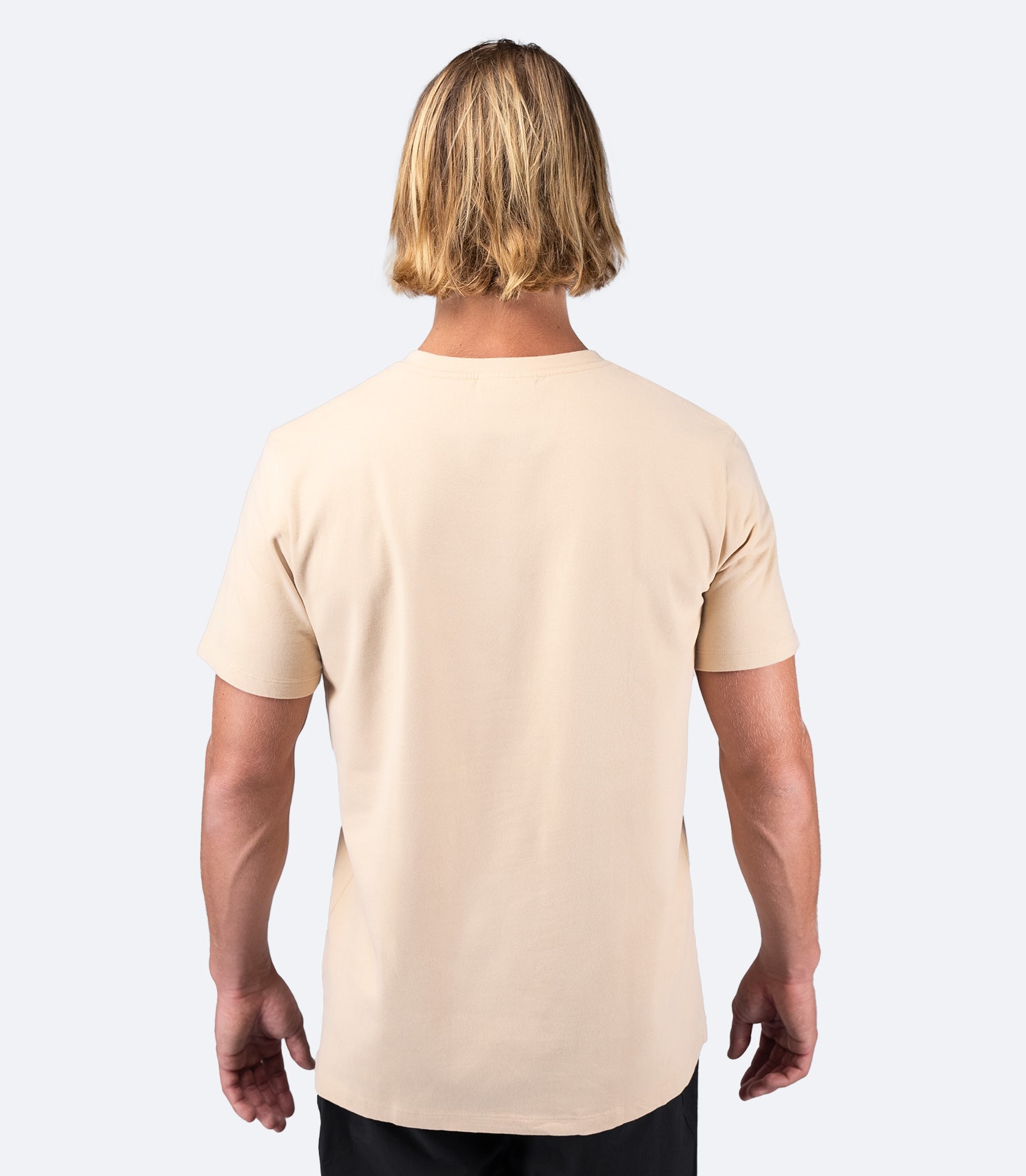 Rear view of Zhik Men's Logo Cotton T-Shirt in Sand, featuring a soft 100% cotton fabric and relaxed fit.
