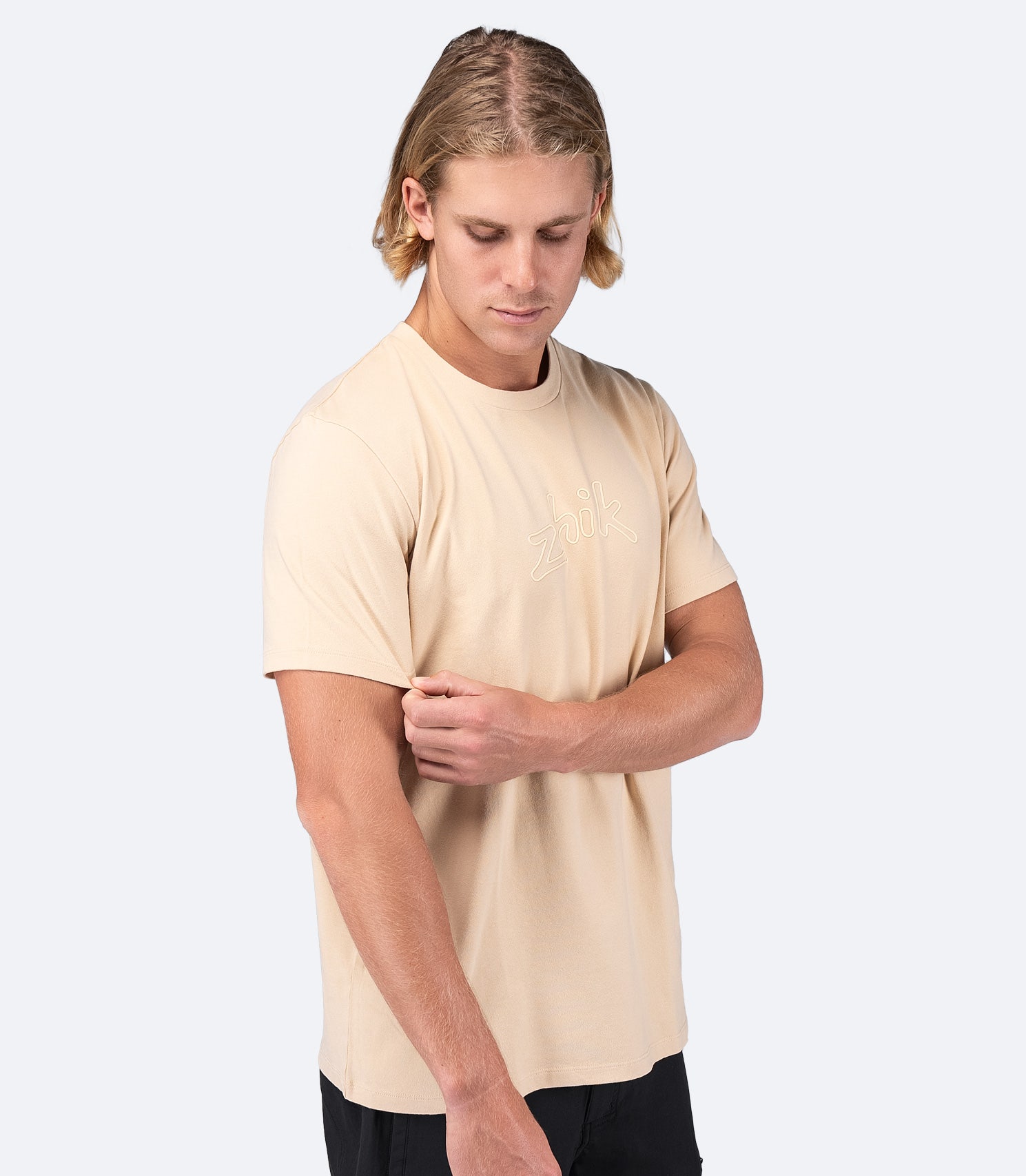 Side view of Zhik Men's Cotton T-Shirt in Sand, showing the relaxed fit and soft fabric for all-day comfort