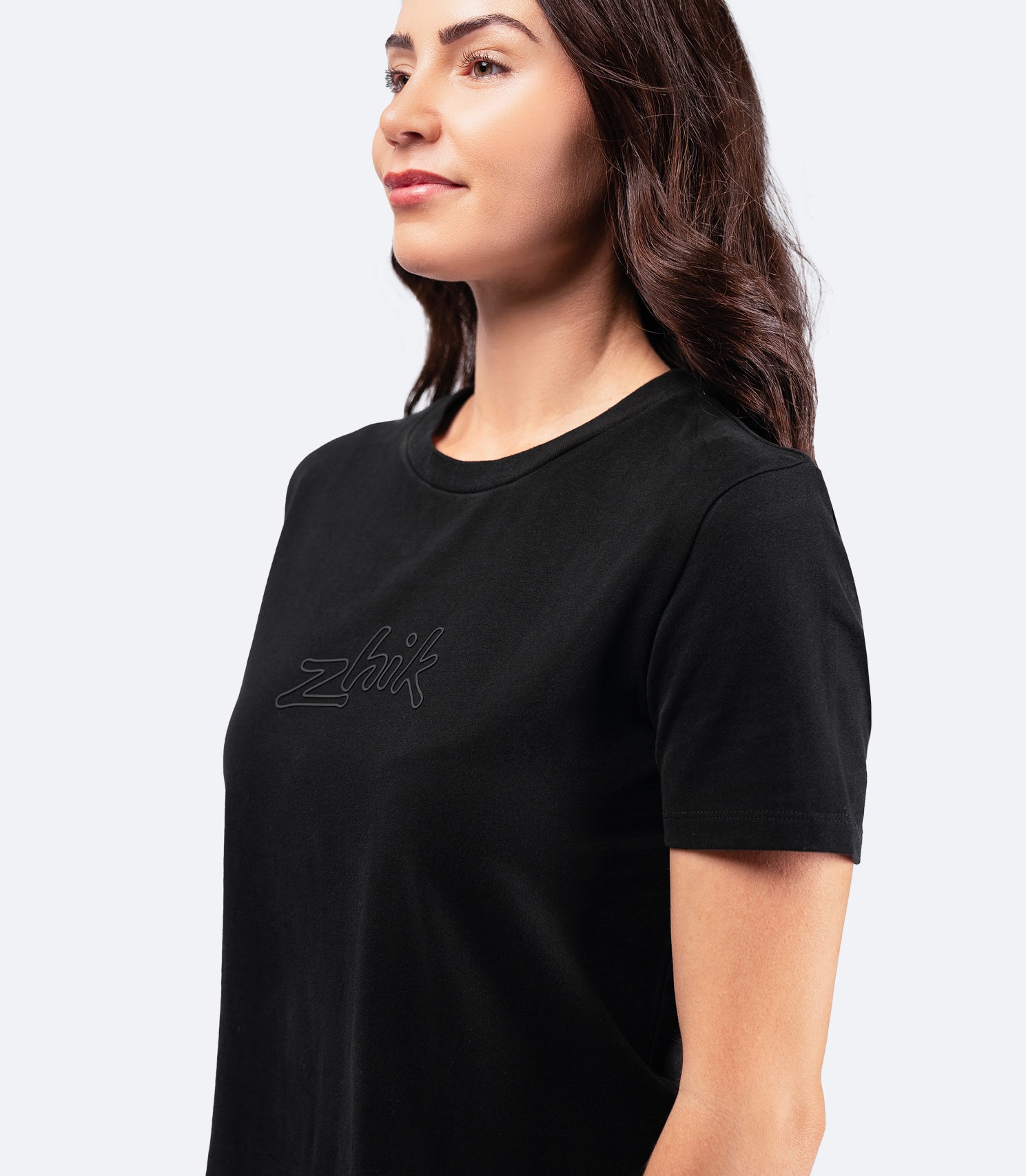 Side-angle shot of Women's Zhik Logo T-Shirt in black, featuring a relaxed cropped fit and durable cotton construction.