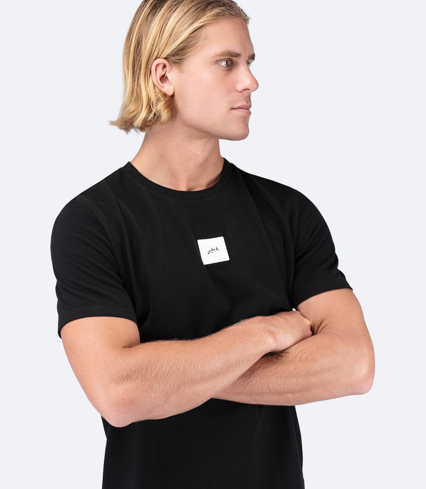 Side view of Zhik Men's Block Logo Cotton T-Shirt in black, showcasing the crew neck design and lightweight cotton construction