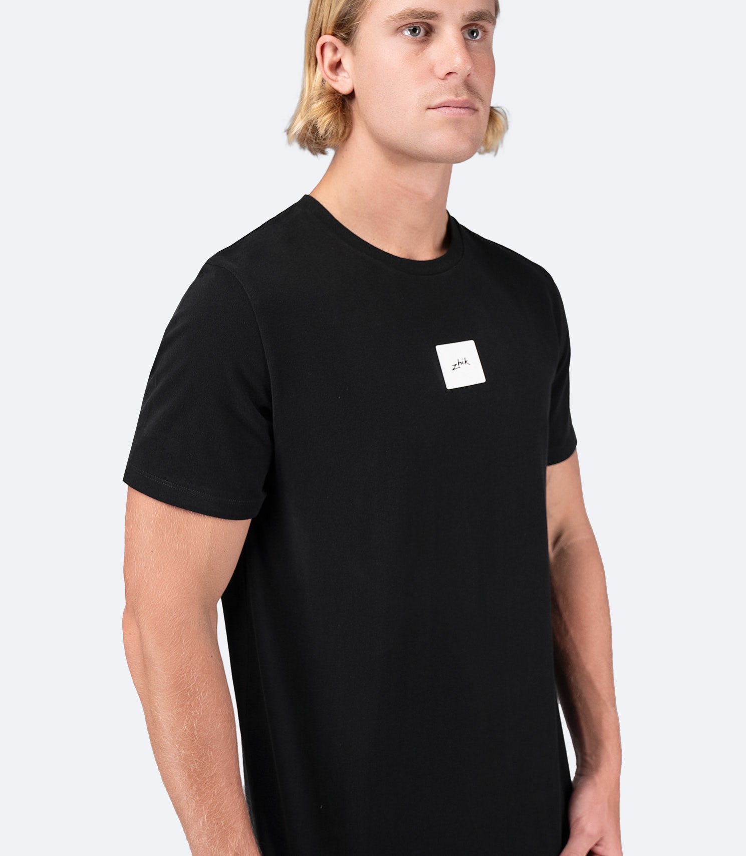 Side view of Zhik Men's Block Logo Cotton T-Shirt in black, showcasing the crew neck design and lightweight cotton construction
