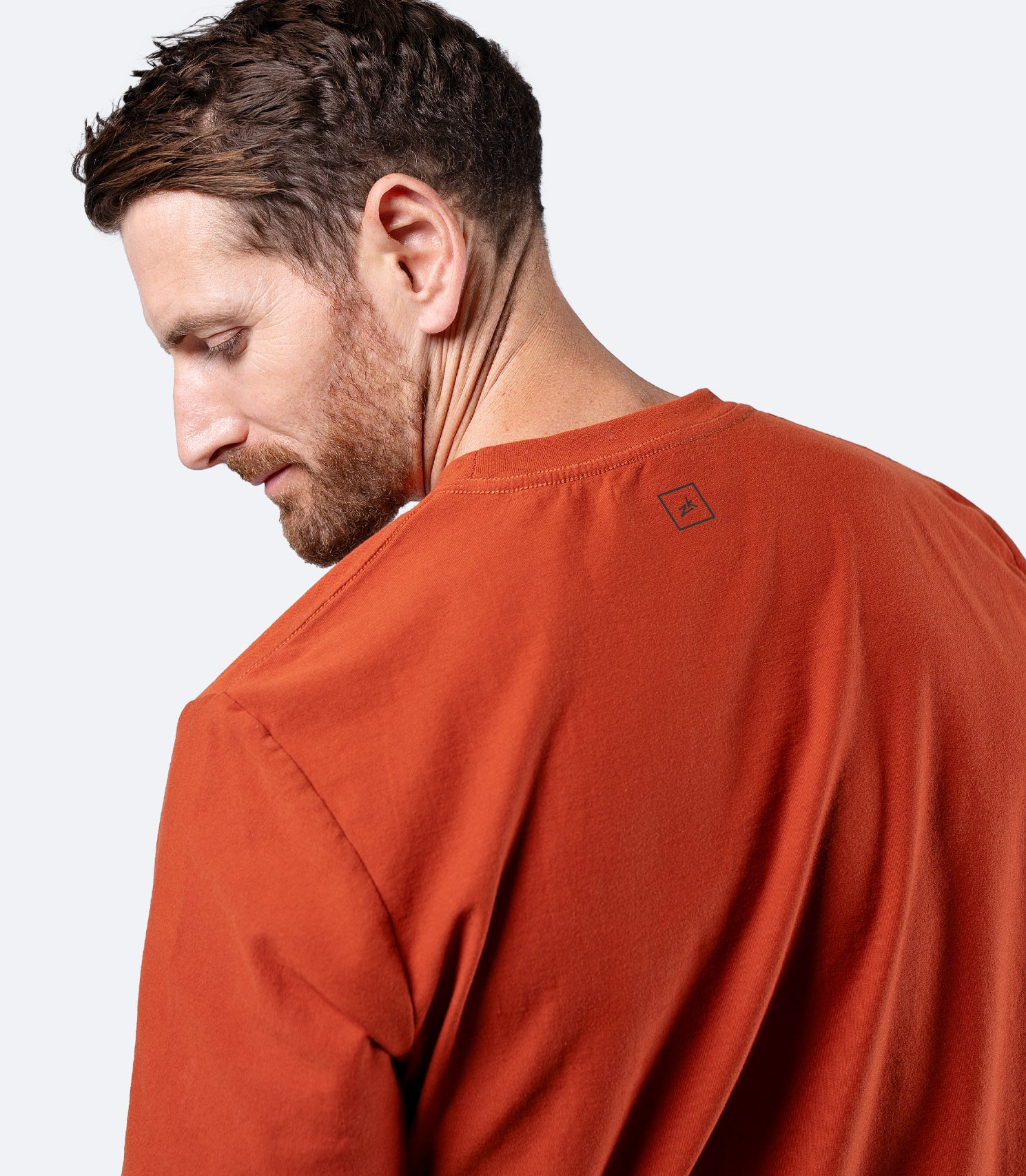 Rear shoulder close-up of Zhik Men's Carbon T-shirt in Red Earth, highlighting seams and structured fit