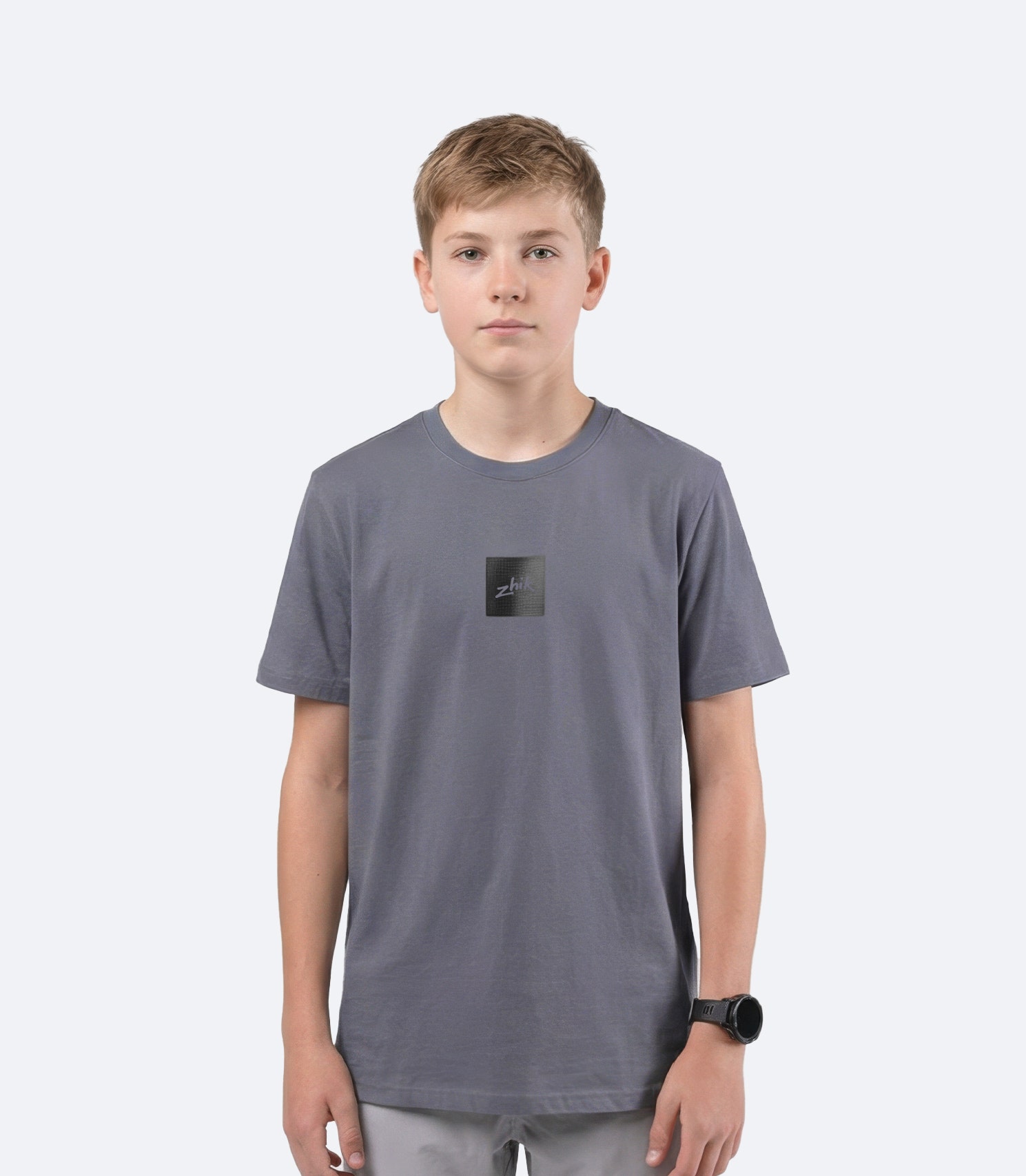 Zhik youth Carbon T Shirt in Slate on male model front view, showing subtle textured Carbon logo branding on chest