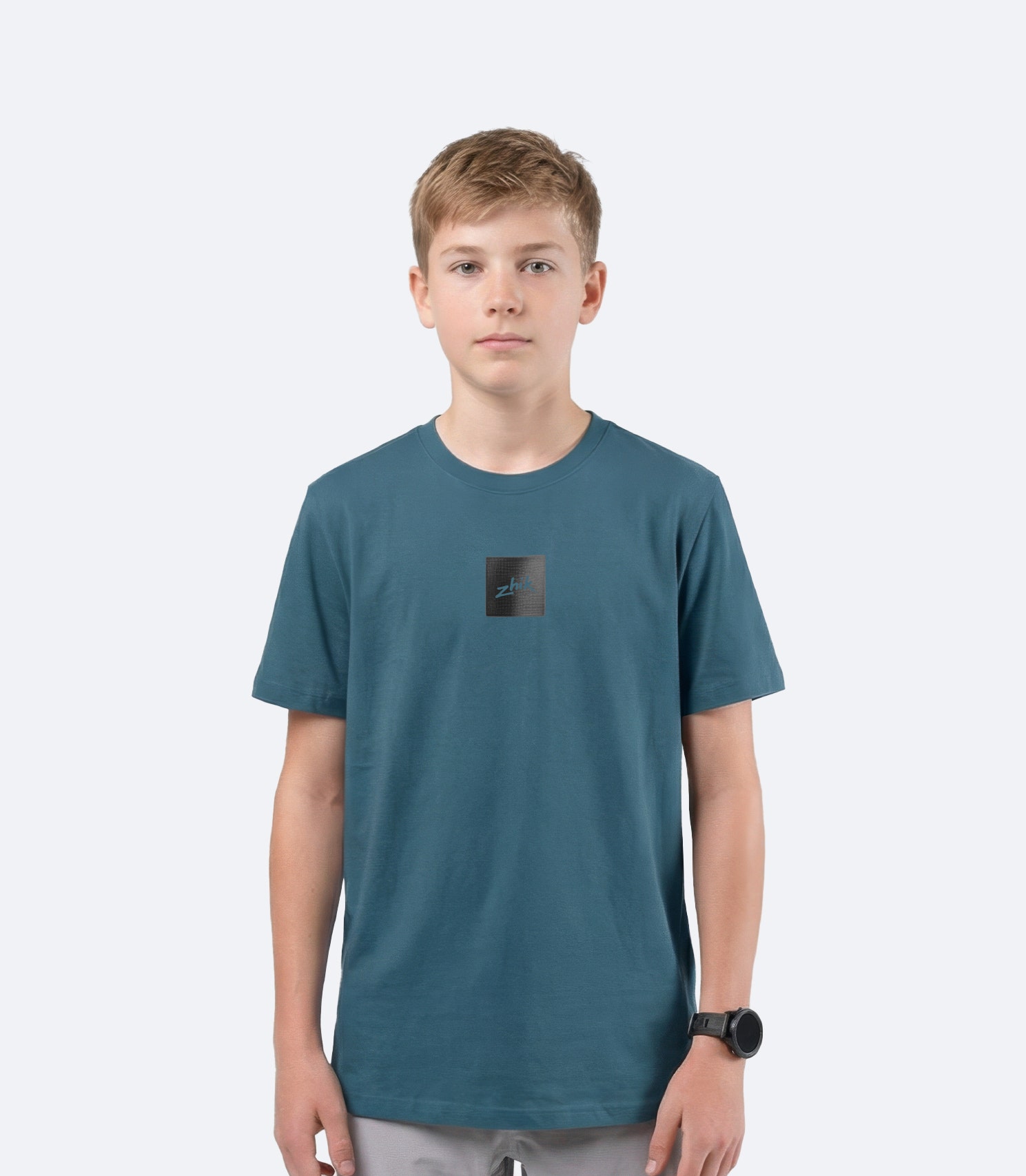 Zhik youth Carbon T Shirt in Deep Teal on male model front view, showing subtle textured Carbon logo branding on chest