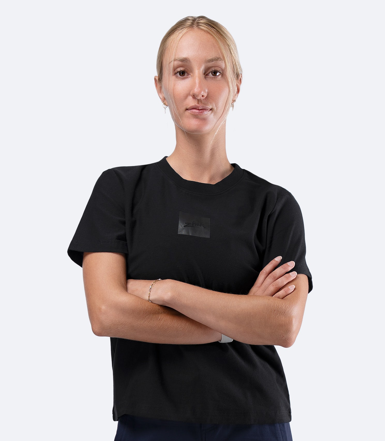 Zhik Womens Carbon T-Shirt in Black, front view with arms crossed, regular fit midweight cotton tee