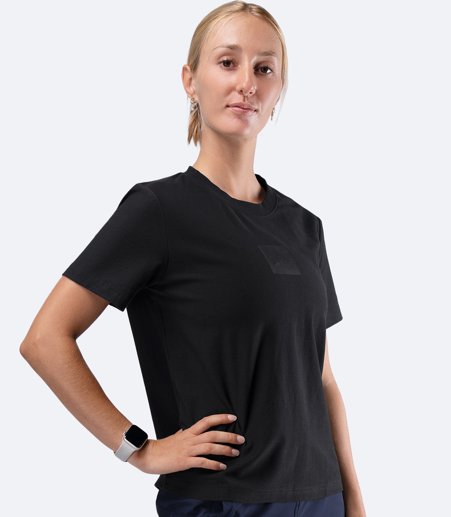 Zhik Womens Carbon T-Shirt in Black, side view with hand on hip, highlighting regular fit and drape