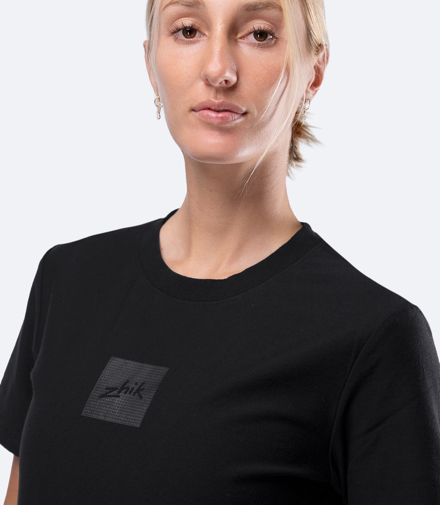 Zhik Womens Carbon T-Shirt in Black, close-up of upper chest showing subtle textured Carbon logo