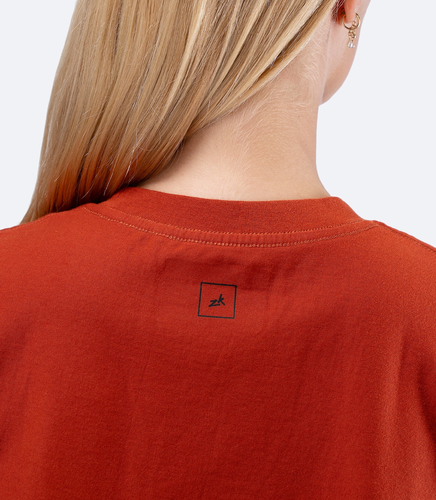 Zhik Womens Carbon T-Shirt in Red Earth, close-up of rear collar with neat stitching and smooth neckline