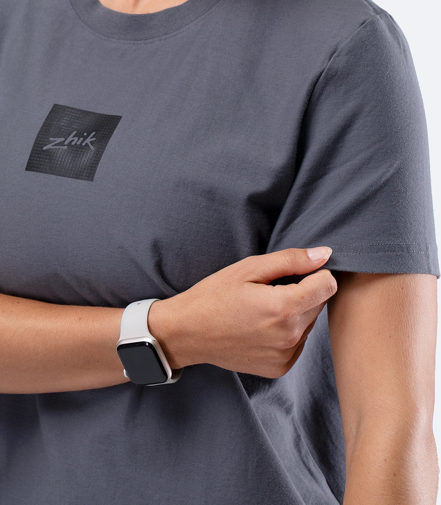 Zhik Womens Carbon T-Shirt in Slate, close-up of hand on sleeve showing soft, comfortable fabric