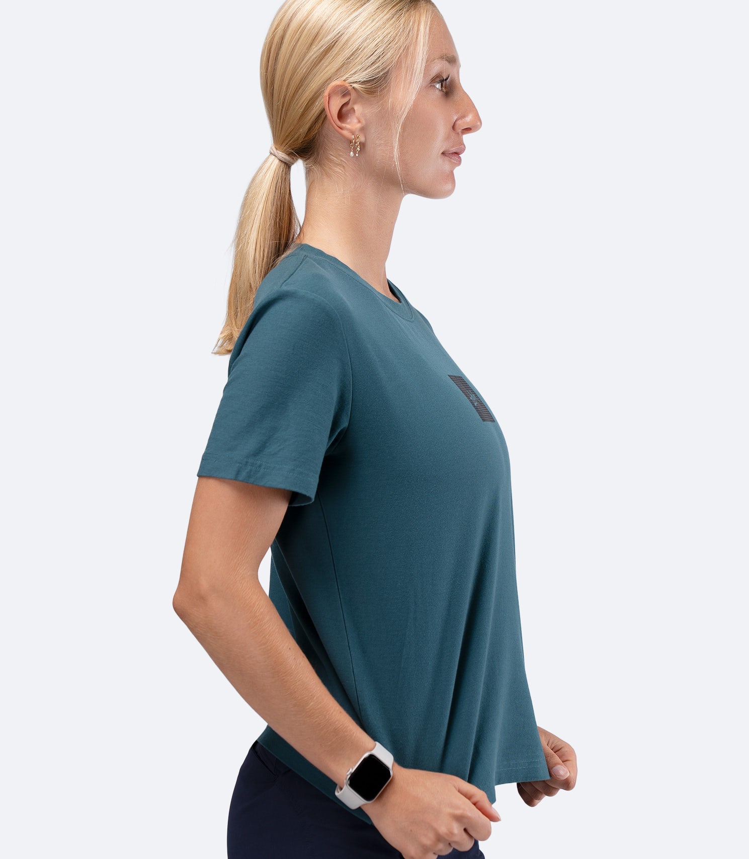 Zhik Womens Carbon T-Shirt in Deep Teal, side view with hand on hip, highlighting regular fit and drape