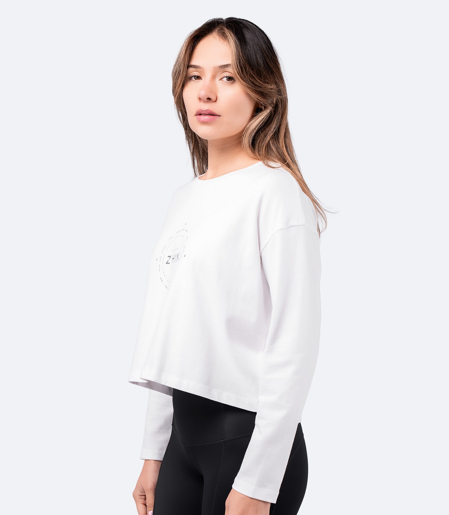 Side view of White Zhik Women's Compass Print Long Sleeve Cotton Tee – soft cotton fabric, cropped fit, and long sleeves for casual wear.